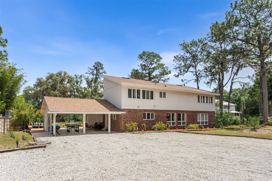 One or more photo(s) has been virtually staged. Properties like this do not come to market. They are passed down. Set on nearly 4 acres with 200 feet of pristine Rainbow River frontage, this is one of the largest and most significant privately held lots on the entire river. Located at the widest section just upriver from KP Hole, the property features its own private dive spring right off the backyard, gushing crystal-clear water year-round. Across the river sits 1,459 acres of preserved state park land, ensuring your view will never be anything but trees, wildlife, and water.

The existing 3,200-square-foot residence is packed with 1974 character and massive potential. It features a sunken living room with vaulted ceilings, a massive kitchen with a step-down utility room ready for expansion, and four bedrooms split between the floors. Upstairs, a spectacular primary suite is reached via a winding spiral staircase and features a private porch and a two-story wall of windows framing the river view. Jack-and-jill bathrooms serve both levels, plus a convenient half-bath accessible from the outside for river days.

Currently operating as a highly successful vacation rental that sleeps up to 20, the property is being sold fully furnished (furnishings negotiable). But the real value here is the canvas. The high, dry land sits outside the 100-year floodplain and carries two addresses on a single nearly 4-acre parcel. There is room to expand the current footprint, build an entirely new secondary residence, or execute a visionary gut renovation to create the ultimate luxury primary home. A new roof was installed in 2024. The property also retains a grandfathered dock footprint on the river, an increasingly rare asset. This is not just a house. It is a legacy holding on one of Florida's most beautiful natural waterways.