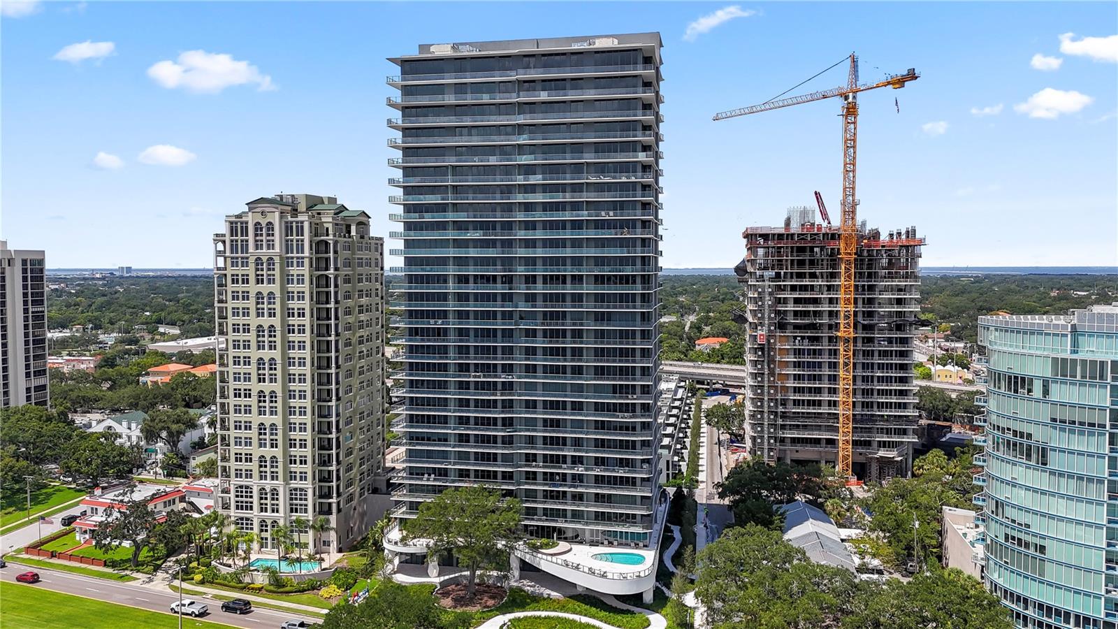 Welcome to the Ritz Carlton Residences Tampa! Here is your opportunity to live in the most sought after new property on Tampa's iconic Bayshore Blvd. This BRAND NEW 3 bedroom + Den/Office has stunning open water, downtown, sunset and sunrise views from this sought after North CORNER unit! This home has unique upgrades not found in other units like Hardwood Flooring; entire home Sonos System including Surround Sound in the Family Room; and Electric Shades installed throughout the entire home. Step off the elevator into your private entry foyer with double doors leading into your home. The 10-foot high ceilings and floor-to-ceiling windows offer abundant natural light and breathtaking views. The kitchen and entire home have high-end finishes synonymous with the Ritz Carlton Brand: SubZero and Wolf appliances complimented by bespoke Stone countertops; custom-designed Italian Cabinetry by Italkraft; large walk-in owner's closet; high-end Kohler plumbing fixtures; and full-size top-of-the-line washer and dryer. A true first class full service building constructed to withstand a Cat 4 hurricane with 24/7 Concierge; both a sunset and a sunrise pool; valet parking; multiple meeting spaces; a large club room; full fitness center; a children's room; golf simulator room; and a full service spa. The Ritz Carlton Residences Tampa is a safe and secure home for you, your family, and your possessions.