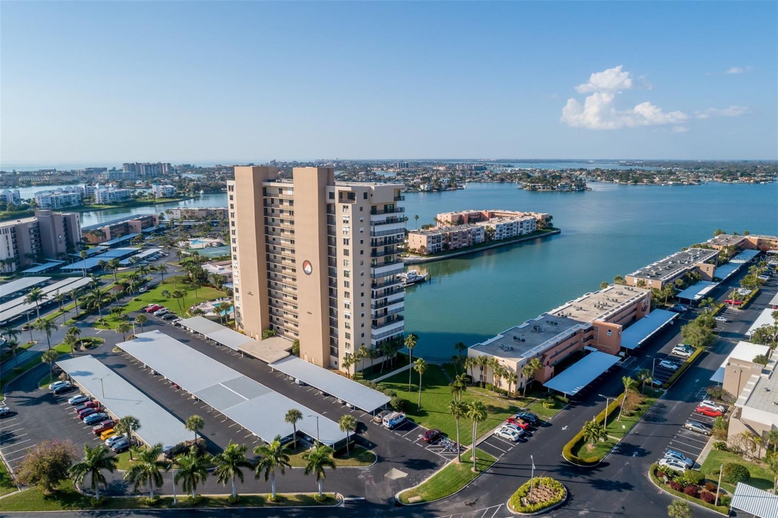 Welcome to your dream retreat in the coveted Admiral Building at Bay Island — a premier 55+ waterfront community offering the best in coastal living! This beautifully updated 1-bedroom, 1.5-bathroom condo is perfectly positioned on the 15th floor offering breathtaking panoramic views of Boca Ciega Bay. Step out onto your spacious private balcony and take in the peaceful waterfront scenery — it’s the perfect spot to start or end your day. The open-concept layout is filled with natural light and modern touches. The kitchen features granite countertops, wood cabinetry, a built-in wine rack, and stainless-steel appliances. Crown molding, elegant baseboards, and thoughtful finishes elevate every space. The oversized primary suite offers plenty of room to relax, complete with a walk-in closet, while the ensuite bath boasts a sitting vanity and a tiled shower with glass doors. A stackable washer and dryer are conveniently located in the renovated half bath. There is generous storage throughout the unit. The highly sought-after Admiral Building provides additional conveniences such as storage closets on every level, extra storage units on the first floor, a designated parking space, and plenty of guest parking. Bay Island is a gated community known for resort-style amenities, including six heated pools, two spas, a marina, a fishing dock, a scenic 1.5-mile waterfront walking path, four tennis courts, pickleball, shuffleboard, his and hers gyms, and a tiki area with gas grills overlooking the bay. Enjoy the vibrant lifestyle offered by the multimillion-dollar clubhouse, featuring a banquet hall, library, table tennis, billiards and card rooms, and a full calendar of social events coordinated by an on-site director. Small pets are welcome to enjoy the Florida lifestyle, with designated dog-walking areas perfect for sunny strolls. In addition, the HOA fee offers peace of mind by covering 24-hour guard security, cable, internet, water, sewer, and trash. Ideally located just minutes from pristine Gulf beaches, world-class dining, premier shopping, vibrant downtown St. Petersburg, and top-tier healthcare, this community offers both convenience and comfort at every turn. Schedule your private showing today—coastal luxury awaits!