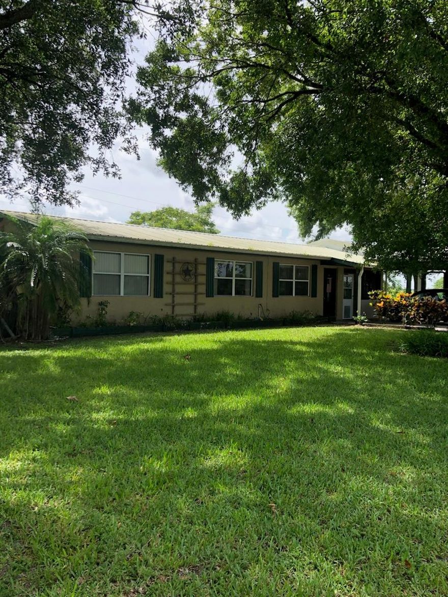 ~Move in ready! CBS Home. Features: Metal roof, ceramic tile, laminate & carpet Flooring in half acre yard with plenty of room for plants or animals. Solid wood kitchen cabinets, and bathroom vanity. Soft close cabinets with stainless steel appliances. Granite countertops. Ceiling fans. Huge master bedroom. Large Florida room. Covered patio & carports. Vertical lateral blinds window treatment throughout. Private water well, and central AC- heater. Concrete driveway. Central A/C-Heat. NO HOA.  New Washer. Less than three yrs water heater, private water Well with less than three years pump motor. Inside laundry room. On Septic. NOT in Flood Zone. Dead-end-street. Easy to commute: 2.5 miles E of US-Hwy 441 and 8.11 miles S of FL-Turnpike. Owner to provide Survey Copy. Call today to schedule a private showing before it is gone! All measurements are approximately. Must measure for exact.