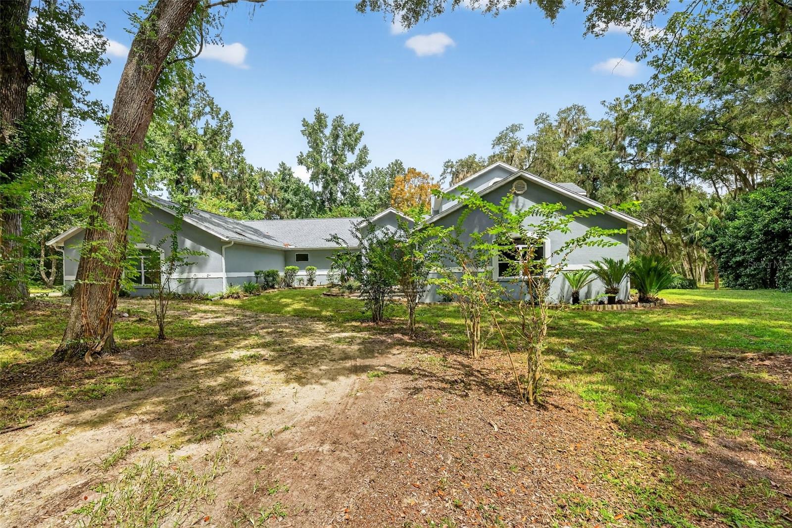 Beautifully spacious 4-Bedroom Retreat on 3.2 Acres in Meadow Wood Farms. Set on a peaceful 3.2-acre parcel in the sought-after Meadow Wood Farms community, this beautifully updated 3,070 SF home blends comfort, style, and functionality. Featuring 4 bedrooms and 2.5 bathrooms, the flexible layout is ideal for both relaxed living and lively entertaining. The oversized living room flows seamlessly from the kitchen and stairway, creating a welcoming space to gather and unwind. A striking staircase leads to the private master suite, complete with a generous bathroom and expansive closet space. Each of the additional bedrooms opens through French doors onto the back porch, offering serene views and effortless access to outdoor living. Recent upgrades including New Exterior paint, sleek new countertops, and new gutters installed in February 2025, add a modern touch, while the 3-year-old roof provides peace of mind. Whether you're dreaming of room to grow or a quiet country escape, this horse-friendly property delivers the perfect blend of elegance and elbow room!