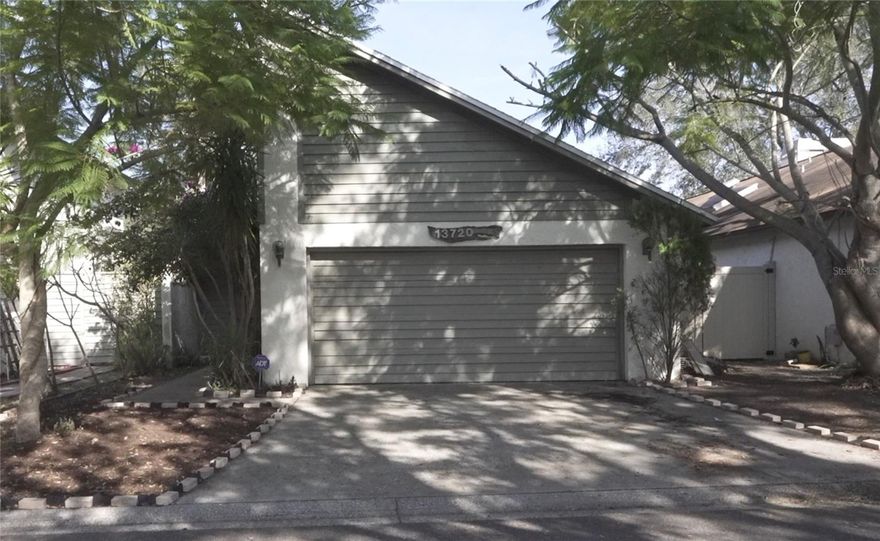 Fabulous 2 bedroom, 2 bath, 2 car garage home in small private community near USF.  When entering the home through the living room, you get a feeling of openness with the cathedral ceilings, but then a little bit of coziness with the fireplace being the focal point of the room. You can access the side yard/patio area from the living room, primary bedroom and kitchen. Washer/dryer are conveniently located in kitchen area. Primary bedroom has en suite bathroom. This small and friendly community includes a pool, grounds and road maintenance as well as pond maintenance. Located close to University of South Florida, Publix, hospitals and a wide variety of small businesses and public transportation.  Conveniently located to major highways and is on the USF shuttle route. This home will be snapped up quickly.