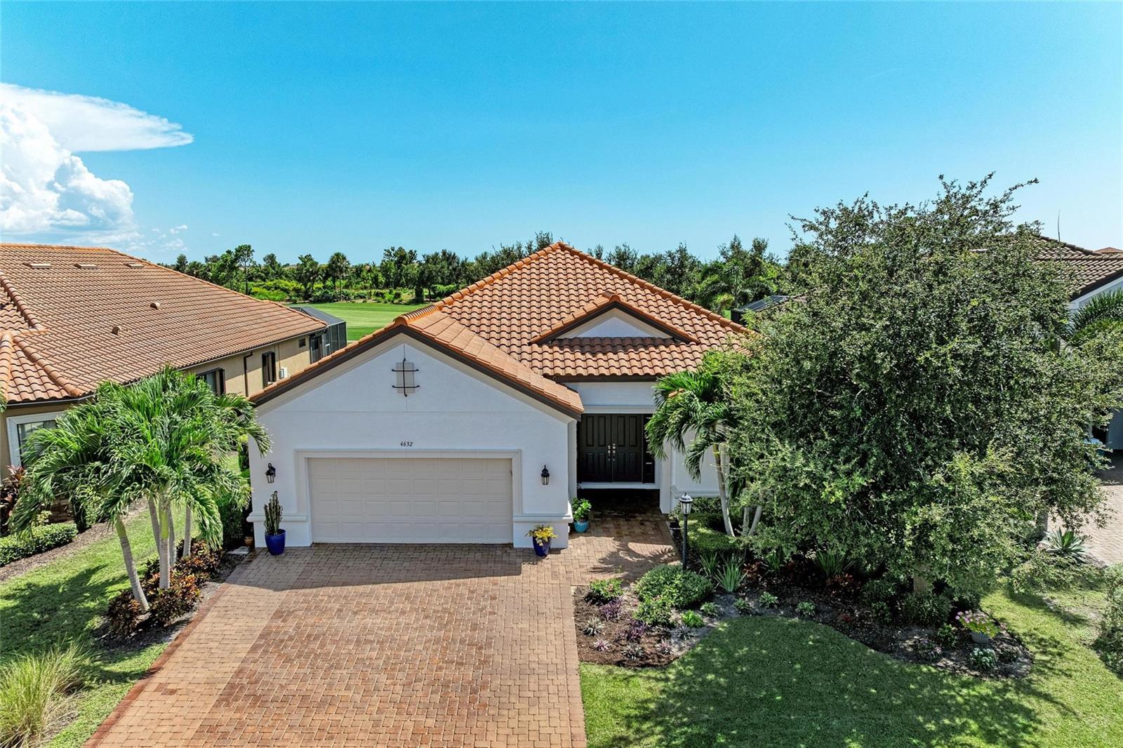 NOW OVER $200K PRICE IMPROVEMENT + FRESH NEW PAINT INSIDE & OUT! LIVE LIKE YOU'RE ON VACATION EVERY DAY in this luxurious golf-front home featuring the highly sought-after Pallazio floor plan in the exclusive Esplanade Golf & Country Club! With a FULL GOLF MEMBERSHIP INCLUDED and breathtaking southern exposure overlooking lush fairways, this home is your ticket to resort-style living at its finest. Upon entering the grand foyer through double doors, you are greeted by adorned columns, a tray ceiling, and soaring ceilings flowing into the expansive open-concept great room featuring crown molding, a tray ceiling, and recessed lighting, bathed in natural light from the disappearing pocket sliding doors opening to the lanai overlooking an amazing 40’ pool, ideal for swimming laps or leisurely enjoyment. The gourmet kitchen showcases Cambria quartz countertops, a decorative crema marfil marble backsplash, and a suite of stainless-steel appliances, including a natural gas cooktop and built-in oven. The oversized island, highlighted by chic pendant lighting, offers ample storage cabinets and is perfect for meal preparation and entertaining. A wine refrigerator adds a luxurious touch to the extended kitchen, which includes a separate breakfast area with sliding glass doors opening to the lanai. The grand primary bedroom, secluded from the guest rooms, has been extended and features a spacious en-suite bathroom with dual sinks, a frameless glass shower, a soaking tub, a private water closet, and a large primary closet. Two guest bedrooms-one with an en-suite bathroom featuring a frameless glass shower and quartz countertops, and another with access to a separate bathroom with quartz countertops and a shower/tub combination—provide comfort and privacy. The generously sized study/den, accessed through newer double doors, offers a versatile space for work and can be easily converted into a fourth bedroom. Outside, the extended screened lanai offers a generous covered area and an expansive paver deck with endless golf course views, inviting you to enjoy Florida's outdoor lifestyle. Motorized hurricane screens add convenience and protection. The driveway was professionally extended to accommodate three cars, ensuring ample space for residents and guests alike. Additional benefits include a roomy laundry room with a built-in utility sink, under-cabinet storage, a drop zone, and garage access, while the epoxy-floored two-car garage boasts multiple overhead storage racks. The gated community offers a wealth of amenities, including an 18-hole championship golf course, tennis and pickleball courts, two fitness centers, two resort-style pools, a full-service spa with a salon, on-site dining at the Bahama Bar and the more sophisticated Barrel House Bistro offering fine dining and cooking classes, bocce ball, a bark park, and endless scheduled events that will fill your social calendar. Lawn maintenance is included in the HOA fees. The award-winning Lakewood Ranch offers a variety of shopping and dining options and is located near University Town Center, the Polo Club, local farmers’ markets, over 150 miles of trails and parks, famous beaches, and SRQ and TPA airports. Don’t miss this opportunity to own this meticulously designed home in one of Florida's premier communities. Furniture available by separate agreement.