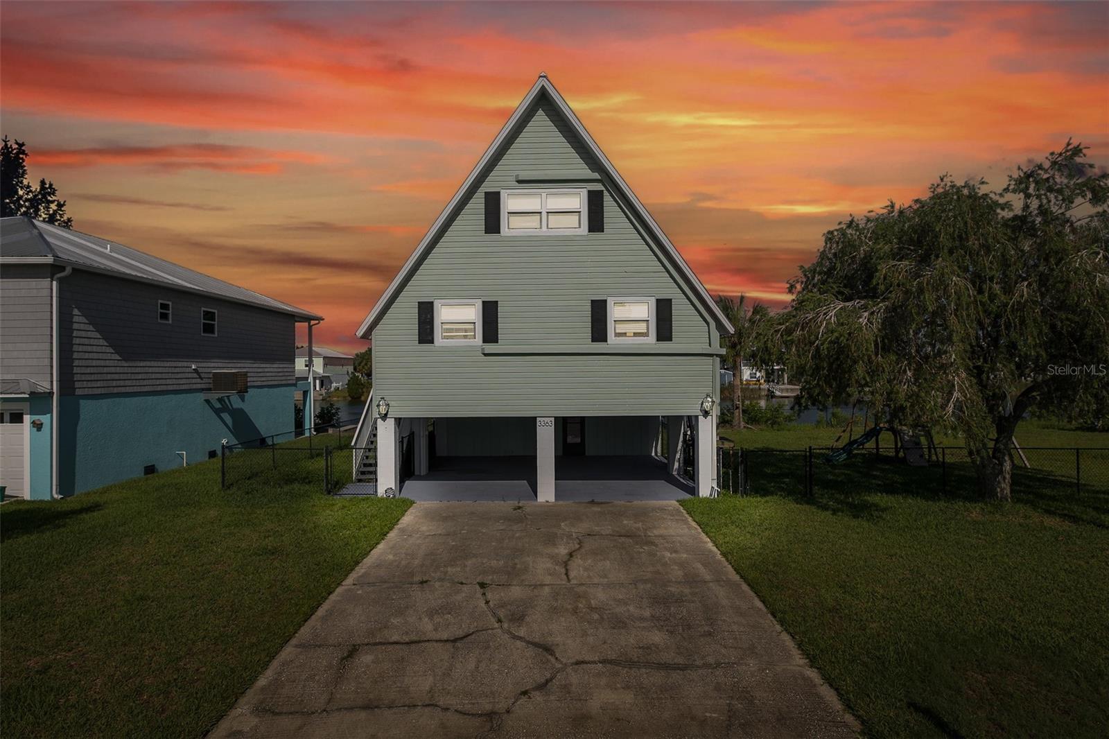 Affordable Waterfront Paradise! Discover this charming 2-bedroom, 2-bath A-frame stilt home with a loft —a true hidden gem in beautiful Hernando Beach! Nestled along the widest canal in the area, the property offers over 60 feet of waterfront with a private dock, perfect for enjoying the Florida lifestyle. Bring your boat, pontoon (up to 25'), or jet ski—Gulf access is available via boat lift. Inside, you'll find 1,440 sq. ft. of living space, plus a bonus enclosed porch (over 300 sq. ft.) that offers stunning west-facing water views—ideal for soaking in peaceful Florida sunsets. Below, a 26x10 deck leads directly to the dock, and the fully fenced yard offers privacy. This home would make a perfect investment, AirBNB, or VRBO with NO HOA, NO CDD, and no rental restrictions. Recent updates include fresh exterior paint, quartz countertops, a stylish new backsplash, a tankless electric water heater, a water filtration system, and energy-efficient mini split units throughout. The roof-over was done in 2014, and there's ample storage available on the main level. Located close to great dining, entertainment, and just minutes from US 19, SR 50, Pine Island, Roger’s Park, and the famous Weeki Wachee Springs and Buccaneer Bay. Only about 45 minutes from Tampa International Airport and just an hour from world-renowned Clearwater Beach. Call today to view this waterfront beauty!