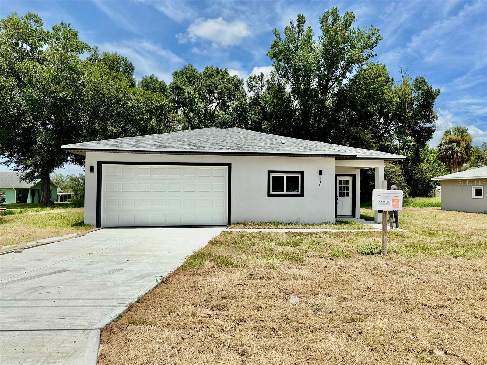 Welcome to your brand-new dream home in the heart of Clermont! This stunning 3-bedroom, 2-bath single-family residence perfectly blends modern design, everyday functionality, and a prime location. Just minutes from Historic Downtown Clermont and the picturesque Lake Minneola Waterfront Park, you’ll enjoy the very best of Florida living — with local restaurants, coffee shops, weekly markets, scenic bike trails, and waterfront activities all right at your doorstep. Step inside to an open-concept floor plan filled with natural light, featuring luxury vinyl plank flooring throughout — no carpet! The kitchen is truly a showstopper, boasting quartz countertops, ivory cabinets, a central island, and stainless steel appliances (refrigerator, range, microwave, and dishwasher included). The spacious primary suite offers a large walk-in shower, modern fixtures, and an oversized closet. Both bathrooms are designed with showers only — no bathtubs, a feature many buyers love. The convenient indoor laundry room comes complete with a utility sink and built-in storage cabinet. Outside, the generous lot offers plenty of space for outdoor living, entertaining guests, or even adding a pool. A covered front porch and sliding glass doors to the backyard create seamless indoor-outdoor flow. The two-car garage, extended driveway, and no HOA or CDD fees make this home even more desirable. Whether you’re looking for your forever home or a smart investment in a rapidly growing area, this property checks every box. Schedule your private showing today — homes like this in Clermont don’t last long!