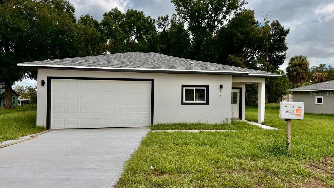 Welcome to your brand-new dream home in the heart of Clermont! This stunning 3-bedroom, 2-bath single-family residence perfectly blends modern design, everyday functionality, and a prime location. Just minutes from Historic Downtown Clermont and the picturesque Lake Minneola Waterfront Park, you’ll enjoy the very best of Florida living — with local restaurants, coffee shops, weekly markets, scenic bike trails, and waterfront activities all right at your doorstep. Step inside to an open-concept floor plan filled with natural light, featuring luxury vinyl plank flooring throughout — no carpet! The kitchen is truly a showstopper, boasting quartz countertops, ivory cabinets, a central island, and stainless steel appliances (refrigerator, range, microwave, and dishwasher included). The spacious primary suite offers a large walk-in shower, modern fixtures, and an oversized closet. Both bathrooms are designed with showers only — no bathtubs, a feature many buyers love. The convenient indoor laundry room comes complete with a utility sink and built-in storage cabinet. Outside, the generous lot offers plenty of space for outdoor living, entertaining guests, or even adding a pool. A covered front porch and sliding glass doors to the backyard create seamless indoor-outdoor flow. The two-car garage, extended driveway, and no HOA or CDD fees make this home even more desirable. Whether you’re looking for your forever home or a smart investment in a rapidly growing area, this property checks every box. Schedule your private showing today — homes like this in Clermont don’t last long!