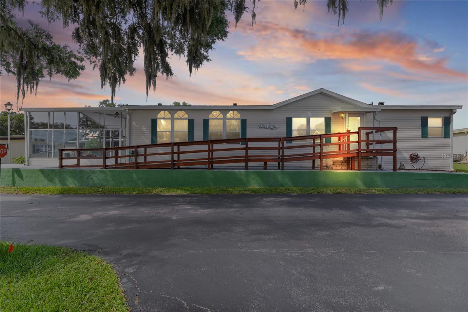 Welcome to this beautifully maintained 3-bedroom, 2-bath manufactured home nestled in a highly sought-after 55+ retirement community. This inviting residence offers comfort, style, and modern upgrades throughout. Step inside to discover an updated kitchen featuring sleek new countertops, a new sink, and a suite of newer stainless steel appliances. The center island is both functional and stylish, complete with a sink, a built-in dishwasher, and a convenient breakfast bar—perfect for casual dining or entertaining guests. Expanded from the kitchen, you'll find a spacious dinette ideal for everyday meals. The open-concept living and dining rooms create a seamless flow, while the split-bedroom floor plan ensures privacy and space for everyone. The large primary bedroom boasts a generous walk-in closet and French doors leading to a luxurious private bath, complete with updated countertops, modern fixtures, and a brand-new tub. Both the second and third bedrooms are roomy and feature new flooring. The third bedroom offers private access to the hall bath, making it a great option for guests or multi-purpose use. An inside laundry area with washer and dryer adds everyday convenience. Freshly painted interior, a roof just over a year old, and a dedicated storage room all contribute to the home's move-in-ready appeal. Relax and unwind in the huge lanai—a perfect spot to enjoy your morning coffee or evening breeze. This home truly has it all—modern upgrades, a practical layout, and a vibrant, welcoming community. Don’t miss your chance to make it yours!