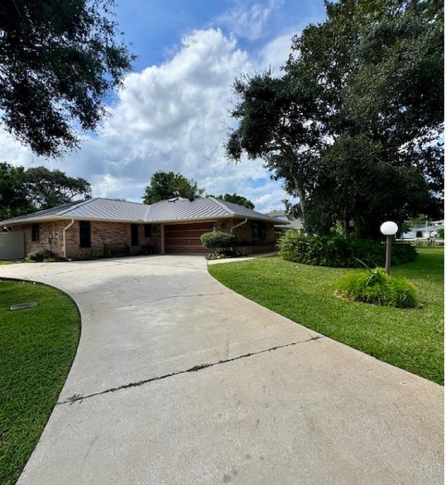 Available starting September 1, 2025, this charming custom built brick home at 156 Live Oak Court is located in the exclusive Sugar Mill Country Club, quietly tucked away at the end of a cul-de-sac and surrounded by lush natural vegetation with numerous nature trails. Featuring 3 bedrooms, 2.5 baths, and a spacious 2-car garage, the home offers both privacy and comfort. The layout includes formal living and dining rooms complete with a 2-piece china cabinet plus a cozy family room with built-in bookshelves and an entertainment center. A large 16 x 20 screened-in porch opens to a fully fenced 30 x 30 pet-friendly yard, equipped with gates on both sides and a doggie door for convenience. The backyard itself extends even farther, offering ample space to enjoy the peaceful outdoor setting. One small dog may be considered. pet is negotiable. Experience the serene lifestyle and mature landscape of Sugar Mill from this quiet, well-appointed retreat. If tenant would like to use the amenities at Sugar Mill, including pools, clubhouse, tennis, pickleball and golf, they will need to acquire their own membership.