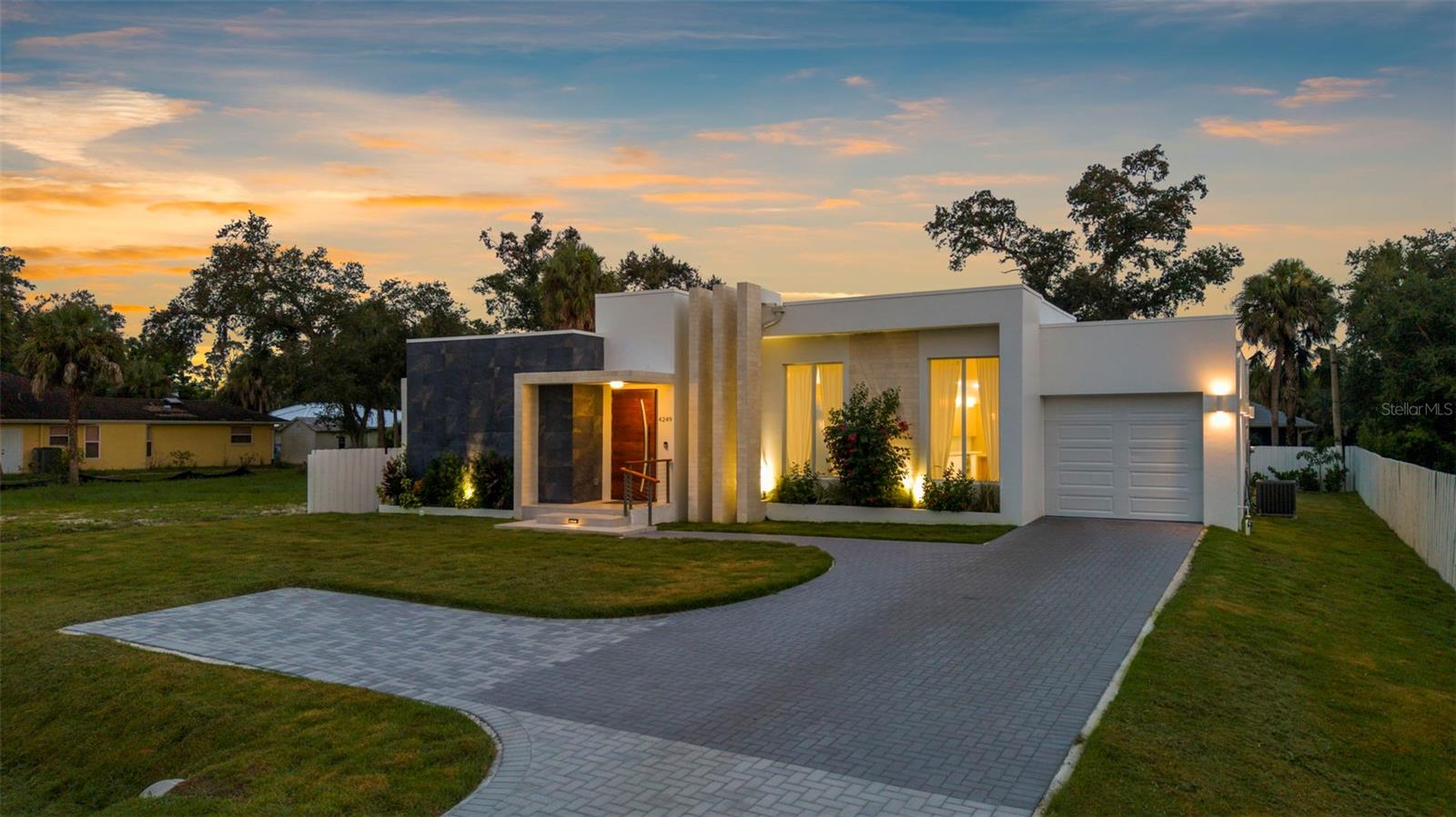 Dare to compare this one-of-a-kind custom-built new construction home in North Port, Florida—there is truly nothing like it! From the moment you arrive, you’ll be captivated by the modern design, stunning paver driveway, lush landscaping with irrigation, and a striking custom redwood door that sets the tone for the high-end finishes throughout. Inside, floor-to-ceiling impact windows bathe the home in natural light, showcasing tile flooring throughout, an indoor laundry room, and a thoughtfully designed open layout that balances comfort and sophistication. The tandem 2-car garage, with a tastefully coated epoxy floor for durability, offers unique parking flexibility, while the fenced yard, private entrance and porch off the primary bedroom, and an additional back porch designed for entertaining create perfect spaces to relax and unwind. Built on a stem wall and positioned high and dry—not in a flood hazard zone where most lenders won’t require flood insurance—this home delivers peace of mind along with beauty. Additional highlights include city water, modern finishes, and meticulous attention to detail that engages all the senses. Conveniently located near beaches, shopping, restaurants, golfing, the Atlanta Braves spring training stadium, and the brand-new Costco, this home blends style, function, and location seamlessly. Schedule your private showing today before this rare gem is gone!