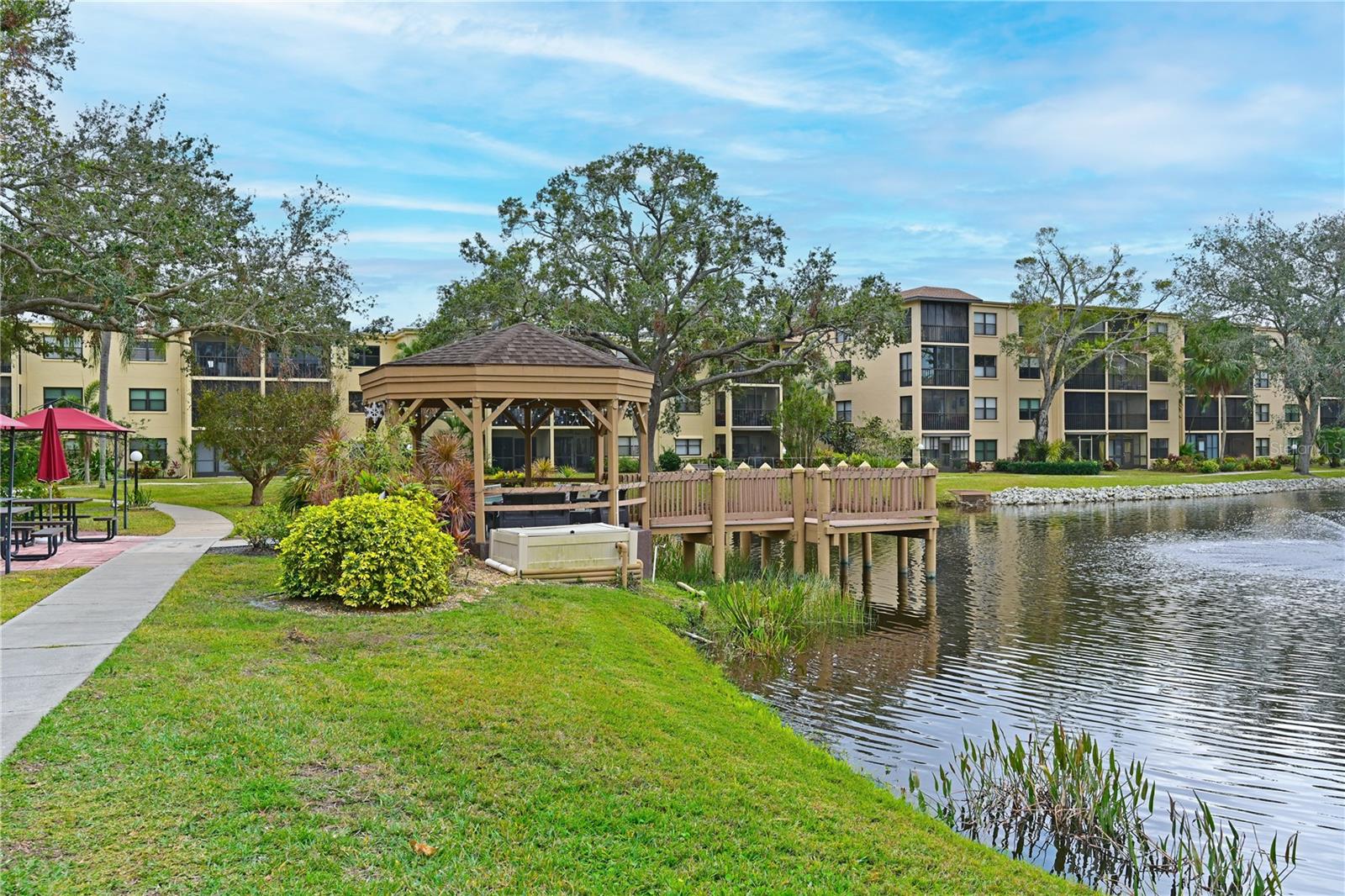 GREAT NEW PRICE - INCREDIBLE VALUE Seller will assist with closing costs! Welcome home to this move-in ready, lovingly cared for 2 Bedroom/2 Bathroom first floor condo in the beautiful 55+ community of Desoto Square Villas. The home features a bright and spacious floor plan with gleaming bamboo-look laminate floors throughout (no carpet!). You'll love the thoughtfully upgraded kitchen, with beautiful white painted cabinets, a designer granite-look countertop, sleek stainless appliances and no more drop-down ceiling! The kitchen is open to the breakfast room, where you'll enjoy the tranquil view of the lake and fountain just outside. That gorgeous view continues as you enter the primary suite, with a large picture window overlooking the lake. Lots of natural light fills the large ensuite, with a walk-in closet and a beautifully upgraded vanity and shower. The secondary bedroom is large, with room for a king-sized bed, and features a double closet and access to the 2nd bathroom through the hallway. The screened lanai is a serene retreat, where you can enjoy mornings and evenings watching the birds and other wildlife in your maintenance free Florida paradise. DeSoto Square Villas is a well-kept 55+ community in the heart of Bradenton, where residents can enjoy lounging by the community pool, playing shuffleboard or tennis, or attend activities at the clubhouse. The community is close to many wonderful shopping and dining venues, including downtown Bradenton's charming main street and Riverwalk, where you can hop on a ferry ride on the river to Anna Maria Island or enjoy an evening under the stars at Bishop Planetarium. You're also less than 2 miles from LECOM park, where you can watch the Pittsburg Pirates hold their spring training, and the Bradenton Marauders play summer baseball. St. Pete and Tampa are just over the skyway, less than an hour's drive, and Sarasota's arts and culture are just 30 minutes south. Live your best life in beautiful Bradenton, FL - call for your private showing today!