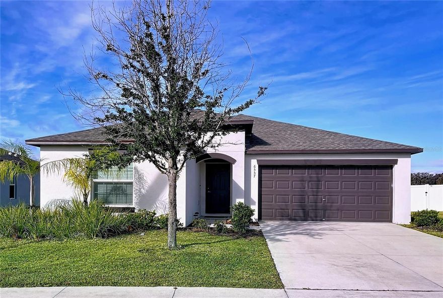 One or more photo(s) has been virtually staged. WHY WAIT FOR NEW CONSTRUCTION? This immaculate 2023-built home is already beautifully upgraded, meticulously maintained, and truly move-in ready—offering the modern luxury and peaceful setting today’s buyers crave. Nestled in the highly desirable Abbott Square community, this 4-bedroom, 2-bath, 2-car garage residence features 1,939 sq ft of contemporary single-story living on a quiet, private lot with captivating POND AND WOODED CONSERVATION VIEWS. Step through the welcoming grand foyer into the light-filled LENNAR Hartford floor plan, where spaciousness and comfort blend seamlessly. At the front of the home, three well-sized bedrooms and a full bath provide an ideal combination of privacy and convenience for family or guests. The heart of the home is the chef-inspired kitchen, showcasing GRANITE countertops, 42” STAGGERED white cabinets, STAINLESS STEEL appliances, recessed lighting, a generous walk-in pantry, and a large island perfect for casual dining or entertaining. The kitchen opens effortlessly to the expansive living and dining areas, creating a true open-concept layout ideal for gatherings. Sliding glass doors lead to your serene backyard retreat—a picturesque outdoor oasis overlooking tranquil water and lush conservation. Enjoy morning coffee as the sun rises, dine alfresco under painted skies, or unwind each evening as the day settles, this setting is extraordinary. The EXPANSIVE OWNER”S SUITE features a spacious walk-in closet and a spa-like bathroom complete with dual granite vanities and an oversized walk-in shower. A dedicated laundry room with upgraded cabinetry, plus an included WASHER AND DRYER, adds everyday ease. The OVERSIZED 2-car garage provides ample storage and functionality. Enjoy LOW HOA fees that include community-wide HIGH-SPEED INTERNET,and TRASH SERVICE enhancing both convenience and value. Abbott Square is a forward-thinking community enriched with ECO-FRIENDLY SOLAR-POWERED STREETLIGHTS and resort-style amenities, including a sparkling zero-entry pool, clubhouse, playground, dog park, walking trails, and outdoor grill areas surrounded by scenic green space. Perfectly positioned in prime Zephyrhills, this home places you near Wiregrass, Tampa Premium Outlets, top-rated schools, major hospitals, golf courses, highly rated restaurants, and the renowned Sarah Vande Berg Tennis & Fitness Center. With easy access to major highways, commuting is smooth and stress-free. This exceptional home delivers more than new construction, with premium upgrades complete, outdoor living, and a setting that offers peace, privacy, and natural beauty. Don’t miss this rare opportunity. Schedule your private tour today!