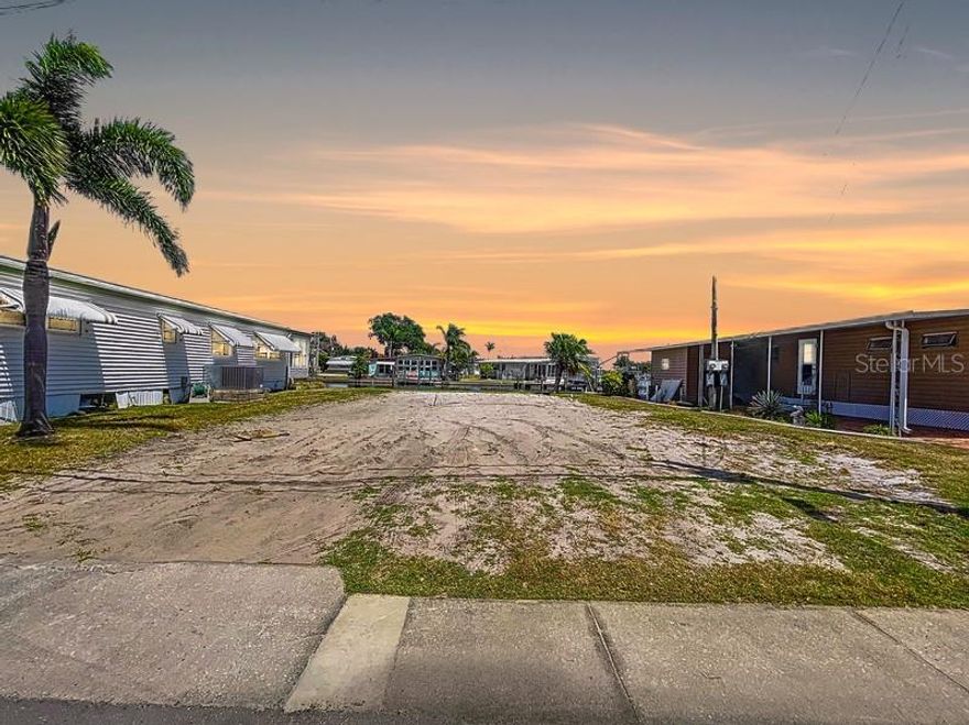 One or more photo(s) has been virtually staged. Welcome to Crystal Bay — A Hidden Gem of Waterfront Tranquility.  Step into the peaceful rhythm of coastal living in this highly sought-after community, where every day feels like a vacation. This rare vacant waterfront lot invites you to create your dream manufactured home in a setting that soothes the soul.  Wake up to golden sunrises shimmering on the water, and sip your morning coffee as gentle breezes dance across the shoreline. With luck, you might catch a glimpse of dolphins or manatees surfacing playfully.  Enjoy exclusive access to a private boat ramp, take a dip in the refreshing community pool, or connect with neighbors in the soon-to-be beautifully renovated clubhouse. Everything about Crystal Bay encourages relaxation, connection, and contentment. Take a leisurely 10-minute stroll to Crystal Beach to witness breathtaking sunsets, or hop on your bike and explore the scenic Pinellas Trail. Just minutes away, pristine shores of Honeymoon Island await.  This is more than a property — it’s a lifestyle of peace, beauty, and belonging. Don’t miss your chance to be part of this truly special waterfront retreat!