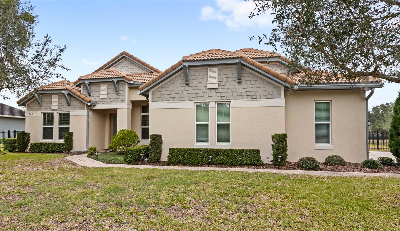 One or more photo(s) has been virtually staged. Welcome home to 31722 Red Tail Blvd! An estate style executive home situated on nearly half an acre on the 7th fairway of the Red Tail golf course. Red Tail is an exclusive gated-community located in Sorrento. The community is pristine and offers some of the best tree-lined streets, walking paths, nature and amenities in the Central Florida area. This home was built in 2015 by K Hovnanian Homes and is known as the Gosford model. The home is single story with over 3,100 square feet and it offers 4 bedrooms, 3 full bathrooms, and a dedicated office. A stand out feature of the floor plan is its triple split layout, maximizing privacy and functionality in the home. This home features a true great room is flooded with natural light and shows off the space with soaring 13 foot ceilings and incredible views out to the private pool and golf course. The views are incredible through the 4-panel sliding glass door! The immaculate kitchen offers double stacked cabinetry, an oversized island overlooking the great room and a gourmet style kitchen layout. It also features upgraded stainless steel appliances and a large walk-in pantry. Just off of the front entrance, the home office is to the left, with glass french doors and large windows overlooking the front yard. Just past the office and to the left is the first guest bedroom and full bathroom. The owner’s suite, situated at the back left of the home, offers expansive sliding glass doors and large windows, making it a light and bright space, with incredible views out to the private pool. It also includes dual walk-in closets. The en-suite offers dual vanities with granite counter tops, a soaking tub and a large shower. On the opposite side of the home are 2 additional guest bedrooms and the 3rd full bathroom. The full bathroom acts as a pool bathroom with a door leading outside to the travertine lanai. Between the 2 guest bedrooms is a bonus space, which is great for kids or guests to have another space to enjoy outside of the great room. Outside, the showstopper of the home is the 22,000 gallon custom-designed saltwater pool with a 6-person spa and an over-sized travertine deck. The pool is fully screened with an oversized screened-in lanai. The pool begins at 4ft in depth and gradually ends at 7ft in depth. The pool is complete with a heater that can be used for the spa and for the pool. The homesite is fully fenced and is nearly half an acre with gorgeous views over the golf course. A few other features about the home: it offers an over-sized 3 car garage, a long paver brick driveway, a dedicated laundry room and it is situated near the entrance gate to Red Tail, giving quick and easy access to SR-46. The roof and driveway was recently soft-washed in August 2024. Beyond the upgraded and amazing design finishes of the home, the community offers everything that you are looking for. Red Tail is a prestigious gated and golf course community with only 300 homes. It is conveniently located off of the Wekiva Parkway, giving you access to the 429 in minutes. The 429 gives you quick and easy commutes to Disney, MCO and Downtown Orlando. In addition, you are equidistance to Mount Dora and Lake Mary, where you can enjoy great shopping, dining and activities. Red Tail is the perfect community to enjoy the nature, fitness center, tennis courts, full-service clubhouse, bar, golf course and more. Call today to schedule a private tour.