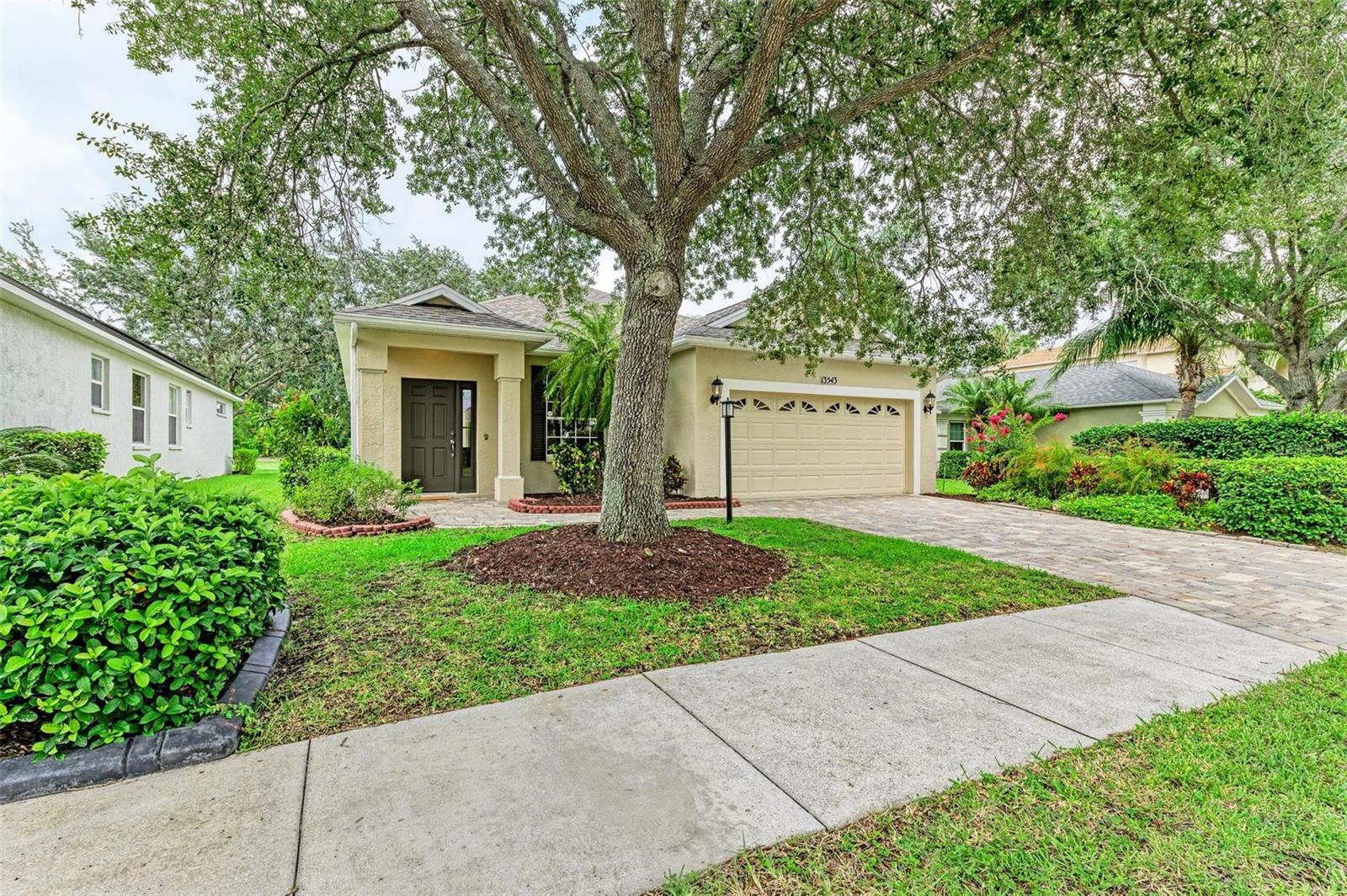 One or more photo(s) has been virtually staged. Welcome to this charming Bruce Williams home located Greenbrook Village in Lakewood Ranch! This 3 bedroom, 2 bathroom residence features a BRAND NEW ROOF installed in June 2024. Inside you’ll find laminate and ceramic tile throughout, crown molding in the living and dining rooms, a skylight, and a luxurious hydro-tub. The eat-in kitchen is well appointed with stainless steel appliances, maple cabinets and solid surface countertops. The home boasts an extended 2-car garage with NEMA 14-50 amp outlet, perfect for an electric vehicle or generator. Enjoy the serene, screened in lanai offering picturesque views of two ponds. Situated in a quiet neighborhood with mature trees, parks, and walking trails. Enjoy all that Lakewood Ranch brings to its residents with less than a 5-minute drive to shopping, gourmet restaurants, recreational facilities, and A+ Rated schools. Don’t miss out on your opportunity to own this exceptional home.