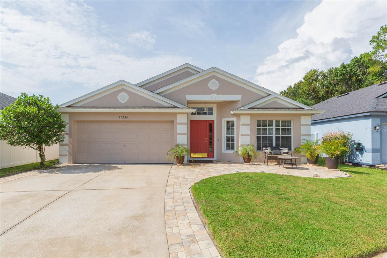 One or more photo(s) has been virtually staged. Tucked away on a quiet cul-de-sac, this impeccably maintained 3-bedroom, 2-bath block home offers refined living in one of Wesley Chapel’s most amenity-rich communities. The open-concept layout showcases a beautifully polished kitchen with quartz countertops, stainless steel appliances, and a seamless flow into the spacious living area—ideal for entertaining. The primary suite is a true retreat, featuring a chic spa-inspired en suite bath with a walk-in shower, garden tub, and private water closet. Additional highlights include a new Roof (2022), HVAC (2019), Water Heater (2025), and premium waterproof luxury vinyl flooring throughout the main living areas (2025). Entertain with ease on the extended front and rear paver patios (2024), perfect for indoor-outdoor Florida living. Enjoy access to resort-style amenities, including three daycare centers, a state-of-the-art fitness and community center, heated pool, splash pad, sports courts, playgrounds, and a stunning 18-hole golf course. Ideally located near major highway access, medical facilities, and upscale shopping, dining, and entertainment.
