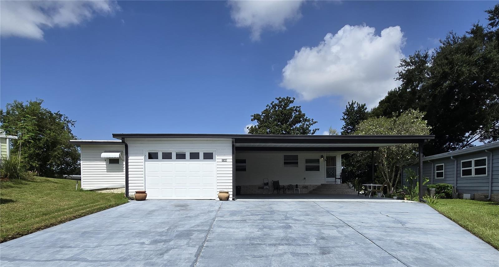 ZELLWOOD STATION 2 BEDROOM 2 BATH HOME located on a quiet cul-de-sac. Kitchen renovated with new cabinets and countertops, and home has new vinyl plank flooring in living, kitchen and bonus room. New a/c 2024, membrane roof, newer windows. 1550 square feet with large primary bedroom! The carport is huge, easily holds 3 cars; PLUS a one car garage with extra storage and a rear storage/office/workshop area (create your own private space!) PRICED TO SELL! ZELLWOOD STATION IS A RESIDENT OWNED 55+ GOLFING COMMUNITY located between Apopka and Mt Dora. HOA ONLY. We have a 72 Par golf course, 4 pools, pickleball and tennis courts; water exercise and line dancing classes and our own Whistle Stop Restaurant and Lounge with banquet facilities. There is always something to do here. Close to the 429 for easy access to airports and attractions, we are close to shopping, restaurants, medical facilities and churches. Come and see what we have to offer!