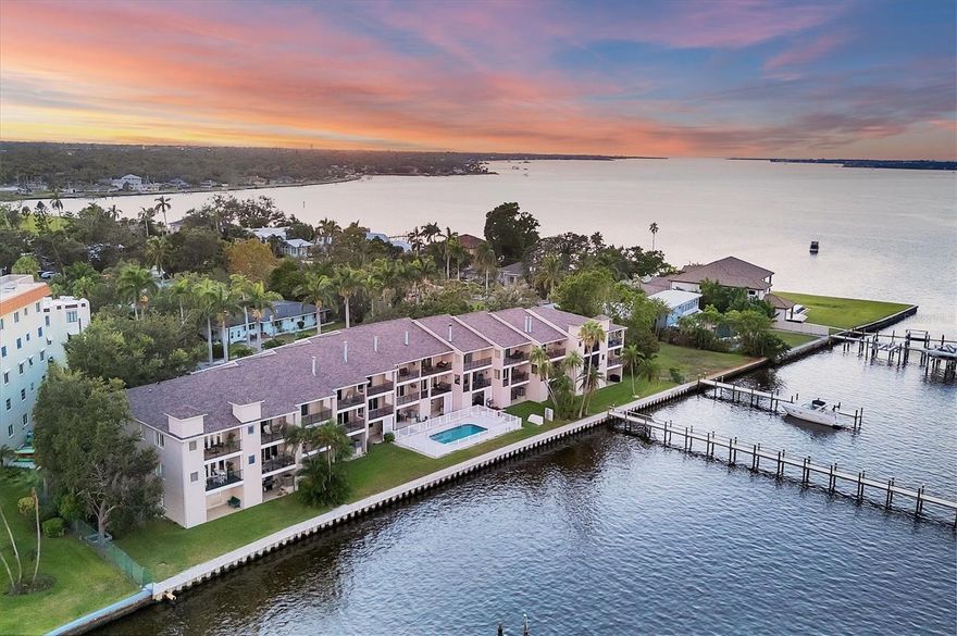 Breathtaking views from this stunning 3 bedroom, 3 bath end unit townhome that comes with your own deeded boat slip with lift that can accommodate up to 12,500 lbs.  An exclusive opportunity to own in this rarely available community of 12 units in the downtown hideaway community of Point Pleasant, convenient to marina, restaurants, and Riverwalk. This home has been beautifully decorated with a unique sense of style, perfect for entertaining family and friends, and you are sure to enjoy the sunset from either of the two porches overlooking the spectacular Manatee River. The private elevator was replaced in June 2025 making it so easy to access the 3 levels, and the A/C was replaced in July 2025. There are plantation shutters throughout along with the majestic crown molding, surround sound system and more. Safety features include a fire sprinkler system throughout and electric hurricane shutters that operate at the touch of a switch.  The 2-car tandem garage has pulleys for storing your kayaks.  Once you see this beautiful condo, you will fall in love!  Call today to see it for yourself.