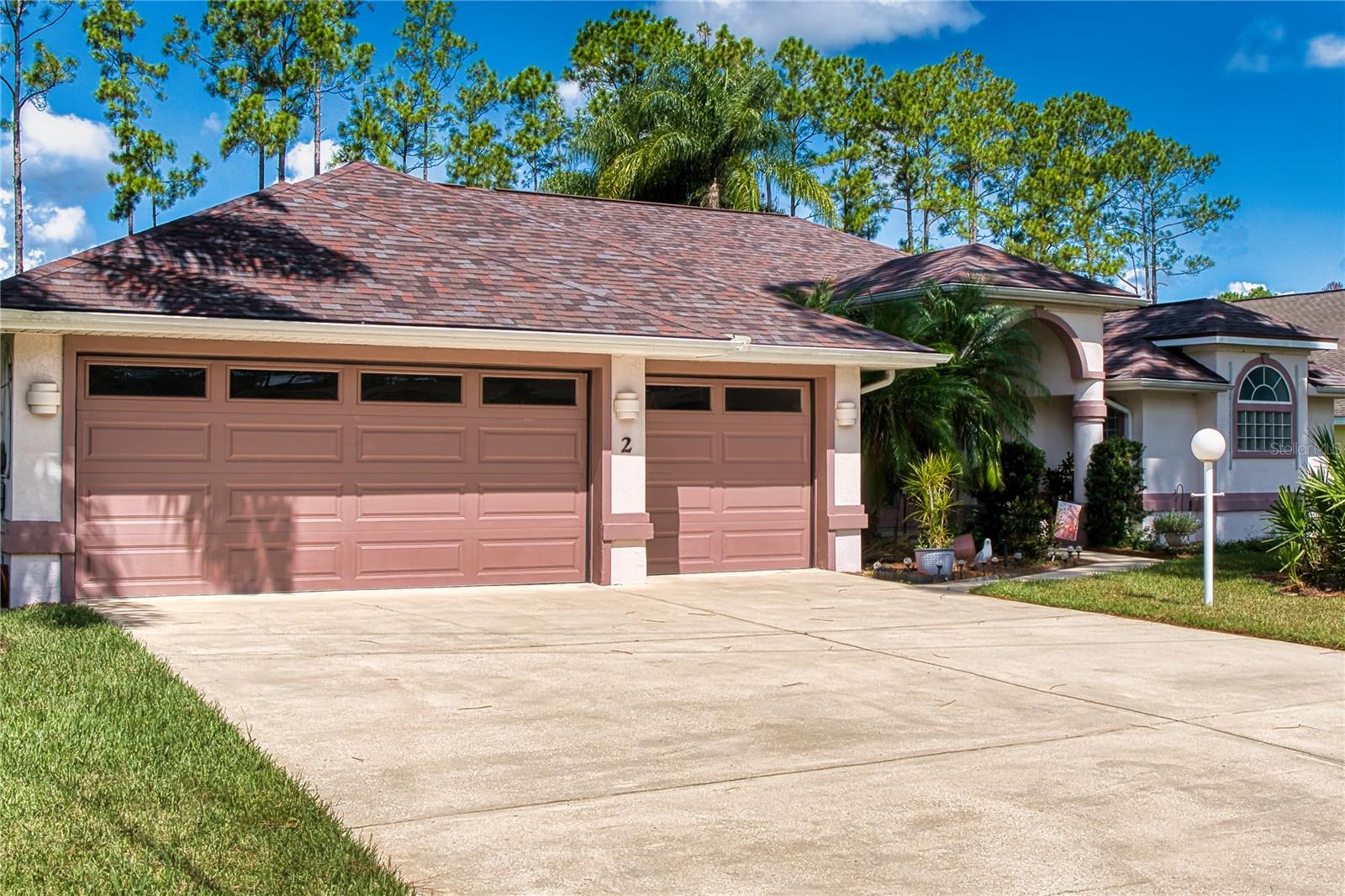 Residing on a private cul-de-sac in Cypress Knoll, this move-in-ready home celebrates Florida nature with a peaceful freshwater-canal backdrop and lush, mature landscaping. An expansive screened wraparound lanai delivers effortless indoor-outdoor living, while an oversized, extra-long three-car garage easily accommodates a fishing boat or full workshop. Inside, double-tray ceilings, recessed lighting, and abundant natural light from skylights and arched windows create an airy, elegant feel. The gourmet kitchen features high-end stainless appliances, upgraded cabinetry with crown and glass doors, a large powered prep island, and beveled-glass windows framing the lanai and greenery beyond. The thoughtful split plan includes a private guest suite with a Jack-and-Jill bath—add a simple door and it converts to a true in-law suite. The primary retreat offers private lanai access and a spa-style bath with dual vanities, a Roman tub, a zero-threshold walk-in shower, and a separate water closet. Additional highlights include an LP-gas fireplace, built-in decorative niches, and a brand-new architectural-shingle roof—an ideal blend of location, flexibility, and nature-forward living in Cypress Knoll.