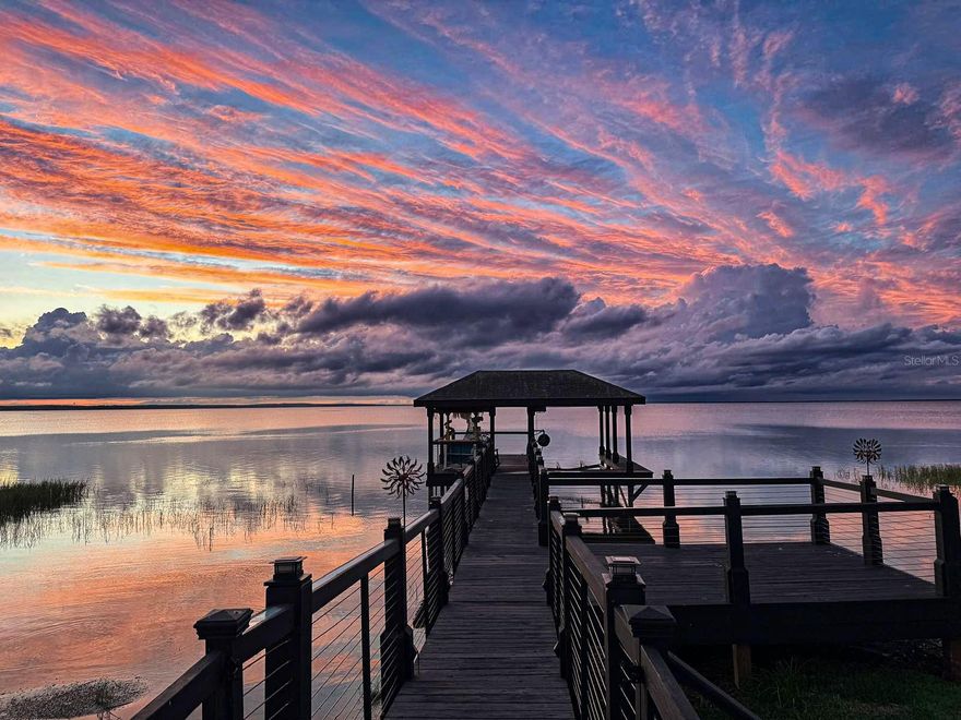 Completely Remodeled Waterfront Luxury Home – Boater’s Paradise on Lake Apopka

Experience the ultimate in lakefront living with this stunning, turnkey home on Lake Apopka in Winter Garden. Boasting over 3,700 sq. ft. of beautifully remodeled living space, this 4-bedroom, 3.5-bathroom residence combines modern luxury with waterfront charm, offering breathtaking sunrise and sunset views every day.

Every inch of this home has been meticulously upgraded with nearly $450,000 invested in renovations, creating a move-in-ready oasis with high ceilings, spacious open-concept living, and designer finishes throughout. Gorgeous porcelain tile and hardwood floors flow seamlessly across two stories, complemented by abundant natural light from all-new, upgraded windows.

The gourmet kitchen is a chef’s dream, featuring quartz countertops, a large island with built-in cabinetry, stainless steel appliances, a backlit quartz bar, and a modern backsplash. Entertain effortlessly in the expansive dining room and living room framing incredible lake views.

The master suite is a serene retreat with two walk-in closets, an oversized Jacuzzi bathroom, and stunning water vistas. Each bedroom boasts lake views, while a second-floor guest bedroom offers privacy, a separate bathroom, and noise-reducing flooring—perfect for a home theater or office. A dedicated office/den at the entrance is ideal for remote work or study.

Outdoor living is exceptional with two enclosed patios on the first and second floors, providing panoramic lake views. Boaters will love the deep-water dock with lift and the fun Margaritaville-themed bar. The backyard features a newly resurfaced saltwater pool, new pool pump, fully fenced secure yard for kids and pets, and mature, landscaped greenery creating a private oasis.

Additional highlights include solar panels, smart thermostat, new HVAC, upgraded irrigation, and a two-car garage with built-ins. Located in a quiet, family-friendly gated community with golf-cart-friendly streets and direct access to the scenic West Orange Trail.

Enjoy Winter Garden’s historic downtown just minutes away, with A-rated schools, shopping, dining, and the famous weekend farmers market. Only 20 minutes to Downtown Orlando and close to Disney, Universal, and major highways without the traffic.

This is more than a home—it’s a boater’s and fisherman’s paradise, a lakefront retreat, and a perfect family haven all in one. Don’t miss this rare opportunity to own a completely remodeled luxury waterfront home with unmatched views and lifestyle amenities on Lake Apopka.