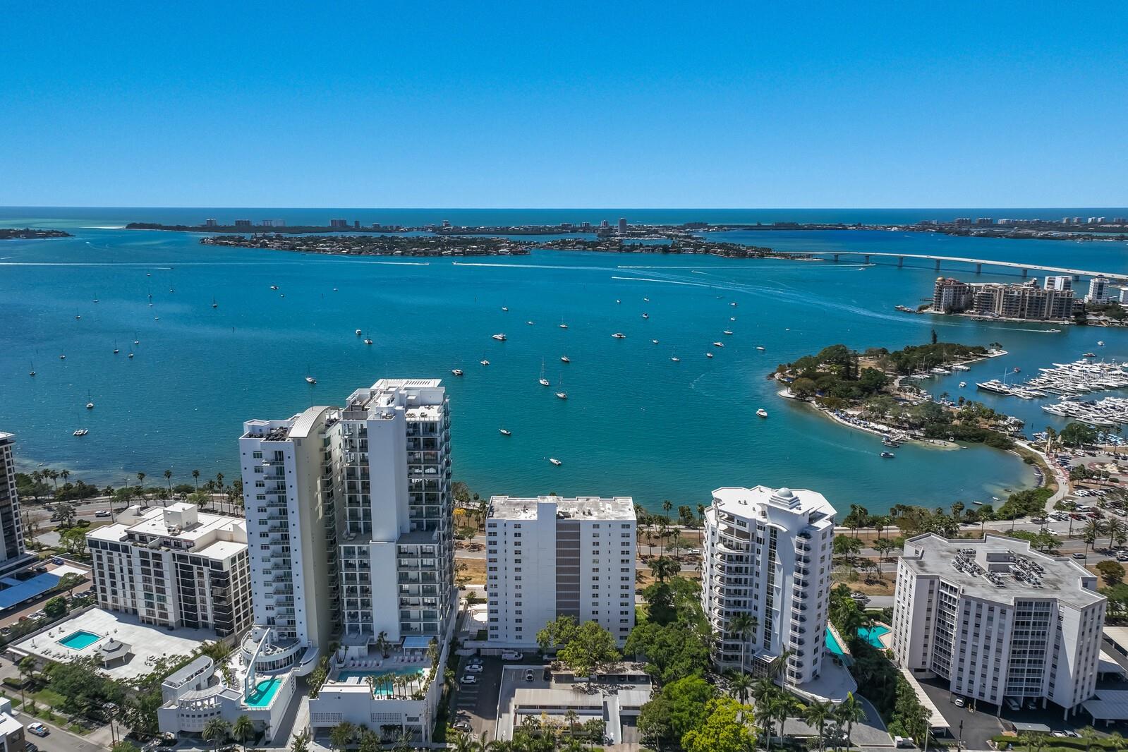 Modern luxury design and stunning unobstructed views across Sarasota Bay delivers an unparalleled opportunity in this fully re-imagined three bedroom, three bath plus office residence in city-centric Royal St. Andrew where downtown Sarasota meets the sparkling Bay. Sunsets via an expansive wall of hurricane-impact windows and sliders become a daily ritual from this spaciously renovated and architecturally redesigned unit that is a culmination of two combined units totaling 3,281 square feet of exquisitely optimal living. Designer touches are abundant throughout including stylish coffered ceilings with recessed LED lights to the offset white oak plank flooring throughout the main living areas below. Flowing seamlessly between the open living and dining rooms is a dual-sided fireplace that anchors the space into kitchen offering remarkably spacious entertainment space with stately expansive counters, custom wood cabinets, a vastly large walk-in pantry with wine fridge, top-quality stainless-steel appliances, and glorious light from the windows abound. The owner’s retreat is a masterpiece in luxurious living with its own separate dressing room area surrounded by a wall of endless closets, an additional customized walk-in closet, a sumptuous bathroom suite with tub, shower, large water closet, and dual sink vanity. The two guest bedrooms are each on their own separate wings of the unit, with one boasting a private ensuite bath, while the other has newly added engineered hardwood floors, This magnificent residence also offers a spacious office smartly positioned to take in the breathtaking views. To round out the story, the sizable home offers a sitting room to take in the views, an enormous laundry room with second refrigerator, sink and cabinets, whole-home water filtration system, 2 storage units, and two parking spaces. The Sarasota lifestyle is a true convenience located between Palm Avenue and Gulfstream Avenue just moments from Burns Court shops and cafés, downtown dining and shopping and a world of cultural attractions. Royal St. Andrew is a well-established condominium community where residents enjoy a heated pool, gorgeously manicured landscaping, lobby, social room with kitchen, and fitness center.