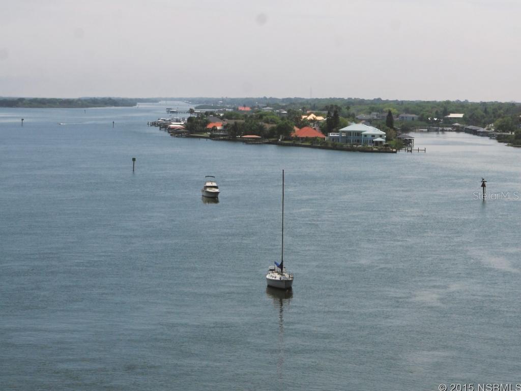 Estate Island Living. The north tip of New Smyrna's prestigious Yacht Club Island; a private, gated community of 25 Intracoastal Waterway homes surrounded by water on 3 sides. The impressive entryway and foyer with soaring 24' ceilings immediately open to the formal living room with wood burning fireplace. a spiral staircase, formal dining room, pillars, and gourmet kitchen. An expansive eat-in kitchen features a breakfast bar with seating for 6, granite countertops, an island with drop-in Thermador range, and stainless appliances. There are 3 sets of double-pane French doors giving access to the private outdoor in-ground heated pool with 2 spill-over spas and paver pool deck. This outdoor living space is a large screened gazebo, perfect for evenings with friends. On the east side, there is space for up to 3 vessels. This home features: Blue tile roof, Crystal chandeliers in the entry and the dining room, Tray ceiling, Built-in buffet, Remote control fans, Central vacuum system, 4 A/C units, Spacious master bedroom with sitting area, Large 37 x 32 upper deck, and surround sound.. ;Water: City
