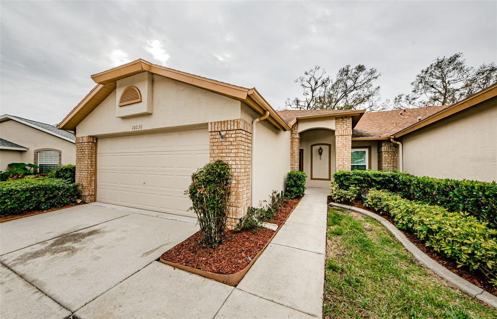 Welcome to your dream Villa in the highly sought OUT Timber Greens 55+ community! This stunning villa located at 10030 Brookdale Dr, ON A CUL-DE SAC effortlessly marries comfort with elegant living. The spacious layout of 1,615 sqft encompasses 2 bedrooms and 2 bathrooms, AND 2 CAR GARGE designed for both relaxation and entertainment. With high ceilings and a bright great room, the space flows beautifully, creating an inviting atmosphere. The kitchen is a chef's delight, featuring gleaming granite countertops and modern kitchen appliances NEW 2024. The primary bedroom boasts laminate flooring and spacious walk-in closets, while the en-suite bathroom offers dual sinks, elegant granite finishes, and a walk-in shower. An additional office/den provides the flexibility to suit your lifestyle needs. Enhancing this home's appeal is the screened-in spa patio enclosure—a private sanctuary perfect for unwinding or entertaining guests. Enjoy seamless everyday living with an laundry room equipped with a washer and dryer. The home is well-maintained, with many upgrades: hurricane-impact windows (2021), an HVAC system (2018), a water heater (2023), and a water softener (2023). The roof was replaced in 2014, ensuring peace of mind in this investment. Located within Timber Greens, this vibrant community provides more than just a home. The clubhouse features a welcoming dining room and the popular 19 Hole Bar & Grill—perfect for socializing and dining without venturing far. Endless amenities await, including arts and crafts, tennis courts, bocce, pickleball, and a beautiful swimming pool and hot tub. Active living is at your fingertips with parks, shopping centers, and more nearby, making this location ideal for fulfilling your active lifestyle. This property offers a spacious lot size of 4,752 sqft and includes a 2-car garage, providing plenty of room for storage or hobbies This villa is a must-see! Comes mostly furnished! Don’t wait—come discover the perfect balance of comfort and luxury in Timber Greens. Schedule your viewing today and take the first step toward your new lifestyle!