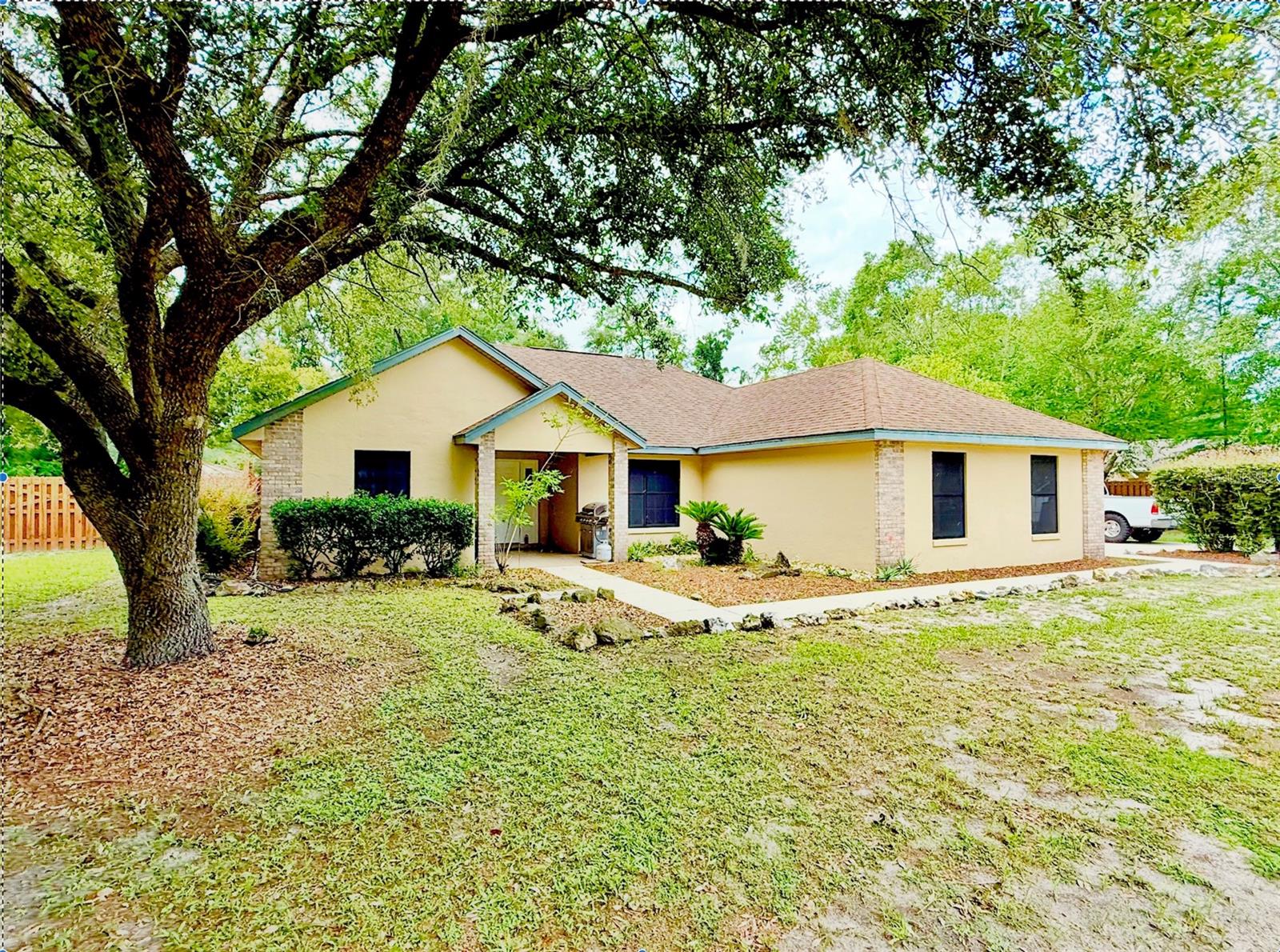 One or more photo(s) has been virtually staged. Beautifully maintained 3-bedroom, 2-bathroom ranch-style home located in the highly sought-after River Glen community. This single-story concrete and stucco residence offers an inviting open floor plan with vaulted ceilings, engineered hardwood floors, tile in wet areas, and carpet in the bedrooms. A brand-new dishwasher has just been installed, adding convenience to the well-appointed kitchen. The spacious living area flows seamlessly into the dining and kitchen spaces—perfect for both everyday living and entertaining.Enjoy the comfort of an attached 2-car garage and the privacy of a fully fenced one-acre lot, ideal for outdoor activities or future additions. A standout feature of the property is the 16’ x 32’ insulated workshop, complete with power, water, A/C, hurricane anchors, and a roll-up door—an excellent space for hobbies, a home business, or extra storage. Ideally located just minutes from downtown High Springs, this home offers quick access to local shops, restaurants, and some of North Florida’s most stunning natural springs. It’s also zoned for highly rated schools, making it a great option for families. With a well-kept neighborhood and an established HOA, this property is the perfect blend of rural charm and suburban convenience. Schedule your private tour today and see everything this incredible property has to offer!