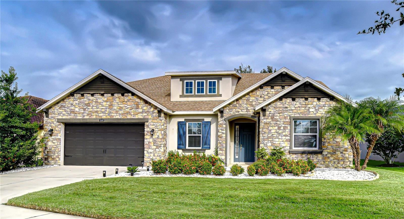 One or more photo(s) has been virtually staged. MOTIVATED SELLER! Welcome Home to this stunning 4 BR/3 BA/2-car garage executive home in the gated community of Waterleaf! The gorgeous European Cottage Stone elevation & lush landscaping create fabulous curb appeal on this desirable conservation lot. The inviting entry w/ decorative ceiling and an art niche leads to the open floorplan featuring 10 ft ceilings, neutral paint & arched entryways throughout w/ tile flooring in all common areas. The formal dining room w/ tray ceiling is a truly flexible space that could be used as a den, office or playroom. The amazing & spacious gourmet kitchen is a Chef’s dream featuring Quartz counters, modern tile backsplash, 42” cabinets, stainless steel appliances including double oven, huge island w/ breakfast bar, walk-in pantry, recessed lighting & a sizable dining area perfect for entertaining w/ access to the covered lanai. The adjacent great room enjoys an abundance of natural light; a tray ceiling & has plenty of space for your sectional sofa. The impressive, oversized Owner’s Retreat features a tray ceiling, 2 walk-in closets, a connected bonus room perfect for an office, private sitting room or nursery and an ensuite bath w/ Quartz counters, dual sinks, makeup vanity, garden soaker tub and a huge walk-in shower. 3 additional bedrooms, 2 full baths, a laundry room & mud area round out the floorplan. The gated community of Waterleaf features outstanding resort-style amenities including an open-air clubhouse w/ covered seating areas perfect for parties, pool w/ pergola & cabana areas, covered playground, 2 dog parks, basketball court, fitness trails and is conveniently located close to everything in the Big Bend/Hwy 301 area and only minutes from I-75, I-4, Selmon Crosstown Expressway, MacDill AFB, schools, shopping, dining, entertainment, beaches, hospitals, theme parks & all the Tampa Bay area has to offer! Don’t miss the chance to make this beautiful property your own…schedule a showing today!