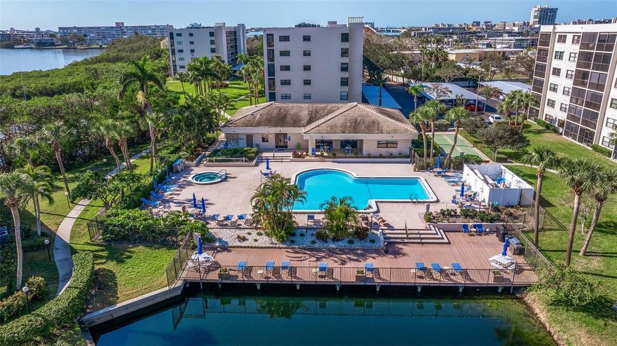 This stunning top-floor residence at Pasadena Cove offers breathtaking water views, capturing the serene beauty of Boca Ciega Bay. In the gated waterfront community of Pasadena Cove, in the heart of South Pasadena, this pet-friendly condominium delivers convenient coastal lifestyle. Bathed in natural light thanks to its prime south-east facing orientation, the home feels bright, airy and inviting throughout the day, without the intensity of direct western sun. The split-bedroom layout ensures maximum privacy, with a spacious primary featuring an en-suite bath, oversized walk-in closet and walk-in shower. The secondary bedroom offers its full bath with a shower/tub combo and generous closet space. The galley-style kitchen is functional and stylish, boasting Corian countertops, tile flooring, plus Whirlpool appliances, including a range and refrigerator. The open living room flows seamlessly to a screened balcony, ideal for morning coffee or evening relaxation, complete with hurricane-rated windows (updated 2020 on the eastern side) and roll-down shutters on the sliding doors. Recent upgrades provide peace of mind, including HVAC (2022), water heater (2025) and a newer roof (2023) for the building. The Milestone Inspection and SIRS have been completed with no assessments. Additional highlights include in-unit washer/dryer, an oversized storage closet on the fourth floor, bike storage, assigned carport parking spot and furnishings included for effortless move-in. Pasadena Cove's amenities elevate everyday living, such as a heated community pool and spa, shuffleboard, billiards, a clubhouse with fitness center, and a private marina offering boat slips for purchase or lease. The gated, waterfront setting includes visitor boat slips, RV/boat trailer parking (additional fee) and direct access to the bay. NO hurricane flooding in any of the buildings at Pasadena Cove! Location is unbeatable, just near Publix, Winn-Dixie, Walmart Neighborhood Market, pharmacies, restaurants, golf courses, beaches and fitness options. The nearby SunRunner bus stop provides easy, car-free access to vibrant downtown St. Petersburg or pristine beaches of St. Pete Beach, Treasure Island and beyond. The Pinellas Trail is minutes away for outdoor enthusiasts, and St. Pete/Clearwater and Tampa International Airports are only about a 30-minute drive. Schedule your private showing today.