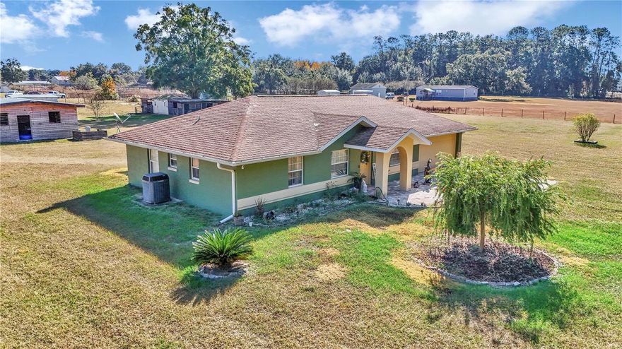 Welcome to peaceful country living, just minutes from every convenience. On three acres, this well-maintained three-bedroom, two-bath block home blends modern updates with the charm of a rural lifestyle. Go inside to an inviting split floor plan featuring fresh interior paint, tile and vinyl plank flooring throughout, and both a living/dining room combo with an electric fireplace plus a separate family room, ideal for flexible living and entertaining. The renovated kitchen and baths offer a contemporary feel with stylish finishes, while a new roof will be installed prior to closing, ensuring peace of mind for years to come. Equestrian or hobby-farm buyers will love the four-stall shed barn, additional carport and ample space for horses, equipment or future expansion. Enjoy privacy and quiet of country life while remaining close to shopping, dining and major highways for easy commuting. This property offers the best of both worlds, comfort, acreage and thoughtful updates in an ideal Summerfield location.