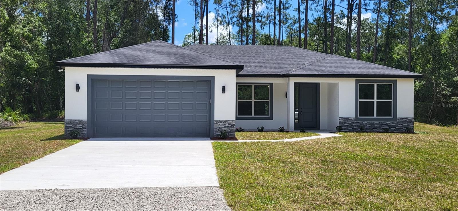 Country living at it's best, yet close to town! SELLER IS OFFERING $10,000.00 IN CLOSING COSTS!!! PLUS AN ADDITIONAL $3, 600 lender credit when you use our preferred lender. You also get a 10 YEAR HOME WARRANTY.. There is NO HOA and NO FLOOD ZONES to worry about!!! This beautiful 3 bedroom 2 bath home sits on 1.14 acres. This home has so may upgrades including, white shaker, slow close cabinets, GRANITE COUNTERTOPS, STAINLESS STEEL APPLIANCES,LUXURY VINYL PLANK FLOORING, BEAUTIFULLY TILED SHOWERS, low e windows and more! ! The open floor plan gives so much light to the home. The kitchen has a beautiful center island with plenty of storage space. The master bathroom has a gorgeous, huge walk in shower and the vanity has double sinks! Half the lot is cleared for your outbuildings or farm animals. It is just a short drive to beautiful Flagler Beaches to have your toes in the sand and Palm Coast for all your shopping needs.