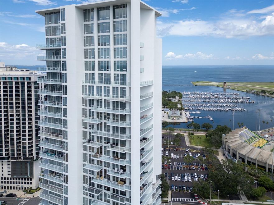 Welcome to Signature Place, downtown St. Petersburg's iconic modern masterpiece-where sleek design, panoramic water views, and a world-class lifestyle meet.
This beautifully updated 2-bed, 2-bath residence spans 1,269 sq ft and features a split floor plan designed for privacy, comfort, and effortless living.

Step inside to find ceramic tile flooring throughout, an open-concept kitchen with Thermador stainless-steel appliances (oven, microwave, cooktop, refrigerator), wine chiller, soft-close cabinetry, and updated baths including an oversized walk-in shower in the primary suite. The guest bedroom is smartly outfitted with a built-in Murphy bed and integrated desk, maximizing livability without compromising aesthetic. Additional upgrades include window treatments on all windows and ample storage space.

An expansive private balcony serves as your front-row seat to breathtaking vistas stretching from Tampa Bay to the Gulf, including views of the St. Pete Pier, Yacht Basin, Al Lang Stadium, Dali Museum, Albert Whitted Airport, and the Skyway Bridge-a truly unmatched backdrop for morning coffee or sunset unwinding.

Signature Place offers an elevated urban lifestyle with 24-hour concierge, a state-of-the-art fitness center, large heated pool, private cabanas, spa, and two stylish club rooms. Perfectly positioned in the heart of downtown, you are steps from Beach Drive dining, waterfront parks, art galleries, museums, concerts, and the famed St. Pete cultural scene. Pet-friendly, with two premium parking spaces and one storage cage included.