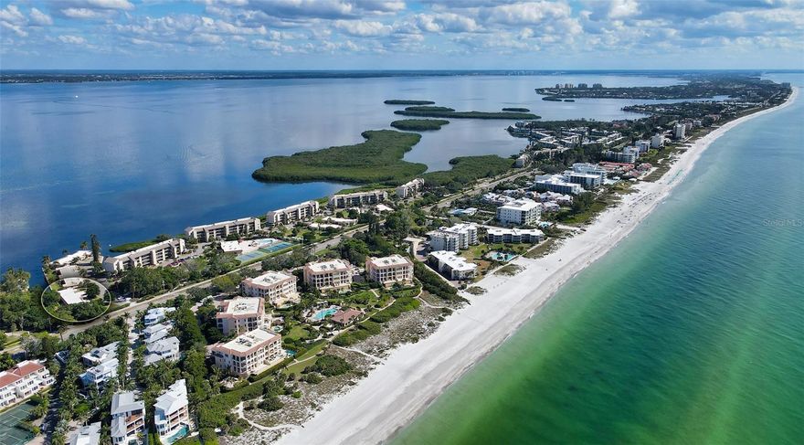 PRICE REDUCED on this rarely available waterfront villa in Windward Bay, which lives like a single-family home while offering the convenience of maintenance-free island living. With nearly 1,900 square feet, this is the largest floor plan in the community and offers beautiful Sarasota Bay and canal views from the main living areas.

The well-designed layout includes a spacious waterfront great room, two large bedrooms, two updated bathrooms, and a flexible bonus room that can easily serve as a third bedroom, home office, or private guest suite with its own exterior entrance. The open kitchen features quartz countertops, stainless steel appliances, generous cabinetry, and overlooks the living space, making it ideal for everyday living or entertaining.

Recent improvements including hurricane impact windows and luxury vinyl flooring throughout provide both comfort and peace of mind. A large interior laundry room with newer full-size washer and dryer offers additional storage and the potential to add a third bathroom if desired. The attached covered carport provides convenient access directly into the home.

Enjoy true Florida waterfront living from the enclosed Florida room and private patio where you can relax, grill, or watch dolphins and manatees in the canal. 
This well-managed community has completed its structural integrity requirements and allows rentals twice per year with a one-month minimum and no ownership waiting period, making this an excellent option for both personal use and investment.  Flood insurance is included in the condo fee for additional peace of mind.

Located directly across from Zota Beach Resort and close to dining, shopping, and the best beaches on Longboat Key, this property presents an outstanding opportunity to own a spacious waterfront residence at an attractive value.Windward Bay offers exceptional resort-style amenities: two heated pools with complimentary chaises, saunas, tennis and pickleball courts, a fitness center, shuffleboard,
boat slips ($60/month with an owner-supplied lift), kayaking and paddleboarding
(storage/launches $40/year), fishing, and three deeded beach accesses. Stroll or bike through 26
acres of professionally landscaped bayfront grounds, or head across the street to Zota Beach
Resort for fine dining and sunset cocktails. This proactive community has passed its structural
integrity inspection and is certified for another ten years. Owners may rent twice per year with a
one-month minimum and no ownership waiting period—ideal for generating income while
enjoying a peaceful coastal lifestyle. Exceptionally pet-friendly, Windward Bay welcomes two
large pets up to 75 lbs each, with pet comfort stations throughout the property. Even Renters can
have pets…a uniquely appealing feature for those seeking rental income. For peace of mind, flood insurance is included in the Condo fee.
Seize this rare opportunity to own a tranquil island haven that combines space, style, and simplicity in a
paradise-like setting. What could be better? It could be yours!