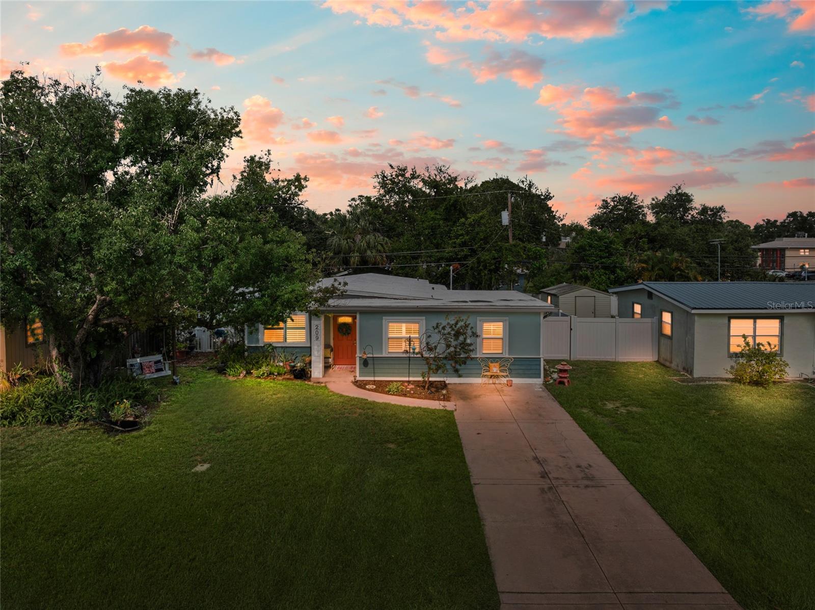 Welcome to 209 Emerald Lane, a beautifully updated residence located in the highly desirable Village Green neighborhood of Largo, Florida. Known for its peaceful, tree-lined streets and central location within Pinellas County, Village Green offers a charming, well-established community with easy access to everything the Tampa Bay area has to offer. This home stands out with its exceptional curb appeal, featuring lush tropical landscaping and a shaded front yard swing—an inviting space to relax and enjoy the Florida lifestyle. Inside, the home boasts a thoughtful blend of custom upgrades and warm finishes. The updated kitchen features stainless steel appliances, custom cabinetry, and modern touches that will impress even the most discerning buyer. Plantation shutters, crown molding, and a tasteful combination of tile and laminate flooring run throughout the home, while the front guest room showcases a beautiful natural wood tongue-and-groove ceiling that adds a distinctive touch of character. A soothing paint scheme enhances the home's relaxed ambiance, and updated windows provide improved safety, energy efficiency, and peace of mind. The split-bedroom layout is ideal for multi-generational living or extended guest stays, while the spacious interior laundry and utility room—conveniently located just off the kitchen—adds both functionality and privacy for guests. The fully fenced backyard offers low-maintenance landscaping, two separate storage sheds, and ample space for gardening, entertaining, or simply enjoying the outdoors. Located just minutes from top-rated beaches, shopping, dining, and essential services, 209 Emerald Lane offers unmatched convenience. Residents are within a 15-minute drive of Indian Rocks Beach and Belleair Beach, and only 20 minutes from the award-winning shores of Clearwater Beach. Outdoor lovers will appreciate being just minutes from Largo Central Park and the Florida Botanical Gardens. Nearby shopping options include Largo Mall and Seminole City Center, while cultural and recreational destinations like the Largo Cultural Center and Highland Recreation Complex are also close by. Healthcare access is another highlight, with HCA Florida Largo Hospital just 7 minutes away and Morton Plant Hospital within 15 minutes. Commuters benefit from quick access to major roadways including East Bay Drive, US-19, and I-275, making travel to St. Petersburg, Clearwater, or Tampa International Airport both fast and efficient. Offering a perfect combination of charm, quality updates, and an unbeatable location, 209 Emerald Lane is a rare opportunity to enjoy comfortable, convenient living in one of Largo’s most beloved neighborhoods. Schedule your private showing today and experience the exceptional lifestyle this home has to offer.