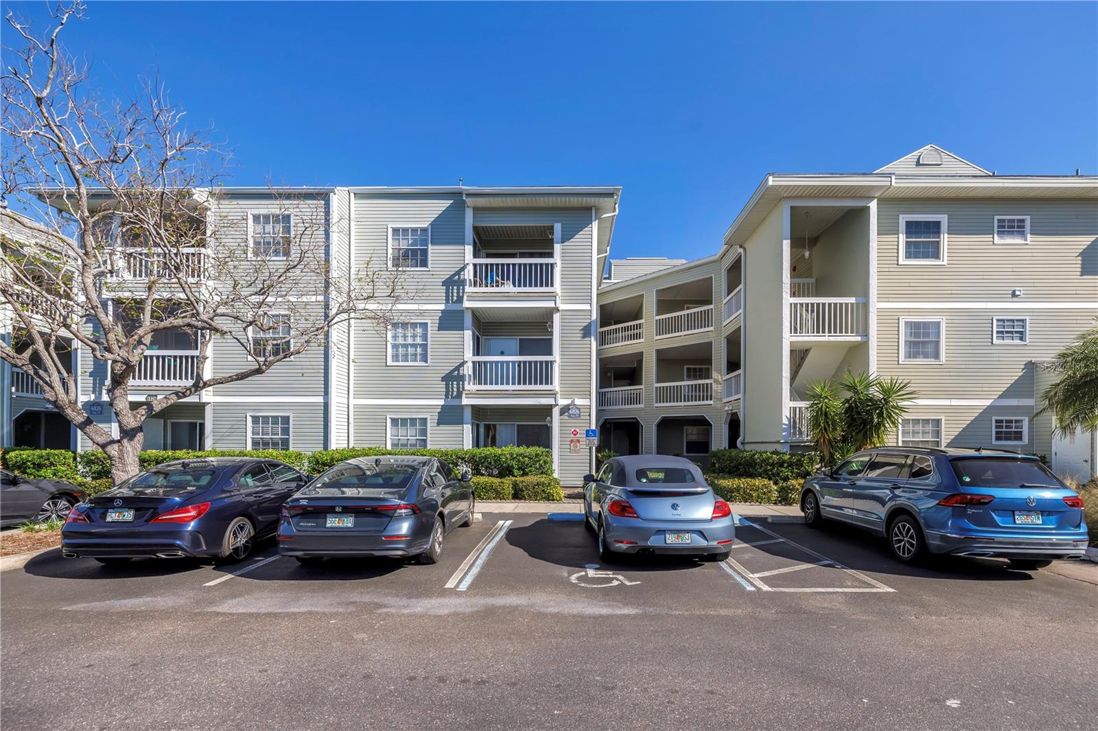 Situated in the heart of St. Petersburg’s Tyrone area, this beautiful ground-floor 2-bedroom, 2-bathroom condo offers a carefree lifestyle with picturesque lagoon views! Freshly painted and featuring brand-new carpeting in the living room and both bedrooms. Plus, the AC system is approximately 3 years old, providing added peace of mind. The spacious, open-concept living area flows seamlessly to a peaceful back patio overlooking the community lagoon, providing the perfect space to unwind. The primary suite boasts a large walk-in closet, private en suite bathroom, and direct access to the patio for added convenience. A full-size washer and dryer are tucked away in the laundry closet near the second bedroom. This unit includes one reserved parking spot, with plenty of guest parking available. The building is highly desirable due to its close proximity to the community’s premier amenities, which include a heated spa, lap pool, updated tennis/pickleball courts, outdoor grills, a community room, and beautifully maintained grounds. Scenic walking paths and charming wooden bridges wind through the tranquil waterway, offering a serene escape just steps from your door. New roof installed 2025! The low condo fees include basic cable, internet, water, sewer, trash, exterior maintenance, groundskeeping, and pest control. Small pets are welcome! This well-kept, non-age-restricted community is just minutes from Gulf beaches, Publix, Tyrone Mall, top restaurants, and downtown St. Pete—plus, it’s less than 100 yards from the Pinellas Trail for biking and outdoor adventures. Don't miss your opportunity to own this charming condo—schedule your private showing today!