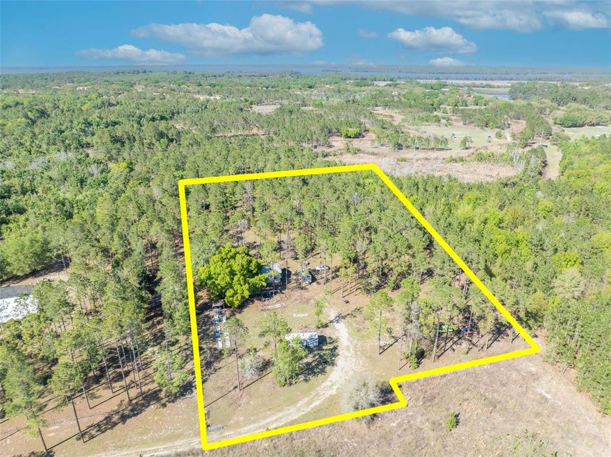 RARE FIND - VACANT LAND- BUILDABLE - HAS WORKSHOP - Discover the perfect opportunity to build your dream home on this beautiful 5.6-acre parcel nestled in the charming town of Howey-in-the-Hills. This private, fenced property offers endless possibilities, whether you're looking to create a peaceful homestead, bring your animals, or cultivate your own garden. Already equipped for convenience and functionality, the property features a 1,500 sq ft workshop with electricity, along with a well, septic system, and RV hookup—making it ideal for immediate use while you plan your future build. Approximately 2 acres of mature timber present a unique opportunity for potential additional income and valuable tax benefits. Previously home to an aquaponics farm, this land is well-suited for sustainable living or a variety of agricultural ventures.  Enjoy the tranquility of country living with no HOA restrictions, while still being just minutes from the Florida Turnpike, shopping, dining, and entertainment. A rare find with so much potential—come bring your vision to life!