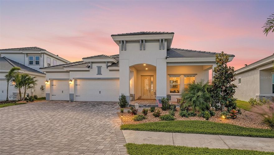 Less than a year old and set on a scenic south-facing homesite with tranquil lake and preserve views, this stunning residence in North River Ranch blends modern luxury with effortless livability. Thoughtfully designed with hurricane impact glass and upscale finishes throughout, the home features high-quality flooring, designer accent walls, and a private office with sliding barn doors. Impressive 12 to 13 ft ceilings define the main living areas and entry foyers, with 10 ft ceilings throughout the rest of the home, creating an elevated sense of volume and light. The open floor plan centers around a spacious great room with a linear fireplace, flowing into a chef-inspired kitchen with a wine bar, large island, gas cooktop, under-cabinet lighting, and an oversized walk-in pantry. The spa-inspired primary suite offers lanai access and a spectacular frameless glass shower, while the additional bedrooms are positioned for privacy. Outdoor living shines with a private pool and spa, clear-view screens, and a built-in gas firepit. A charming front porch completes the welcoming feel. North River Ranch is a master-planned community designed for staying active and connected, with multiple amenity centers—including the expansive Camp Creek clubhouse with a resort-style pool, waterslide, and Snack Canteen. Residents also enjoy miles of bike trails and a convenient bike-share program, supporting a vibrant, outdoor-focused lifestyle. Ideally located just a short drive to Lakewood Ranch, St. Pete, and Tampa.