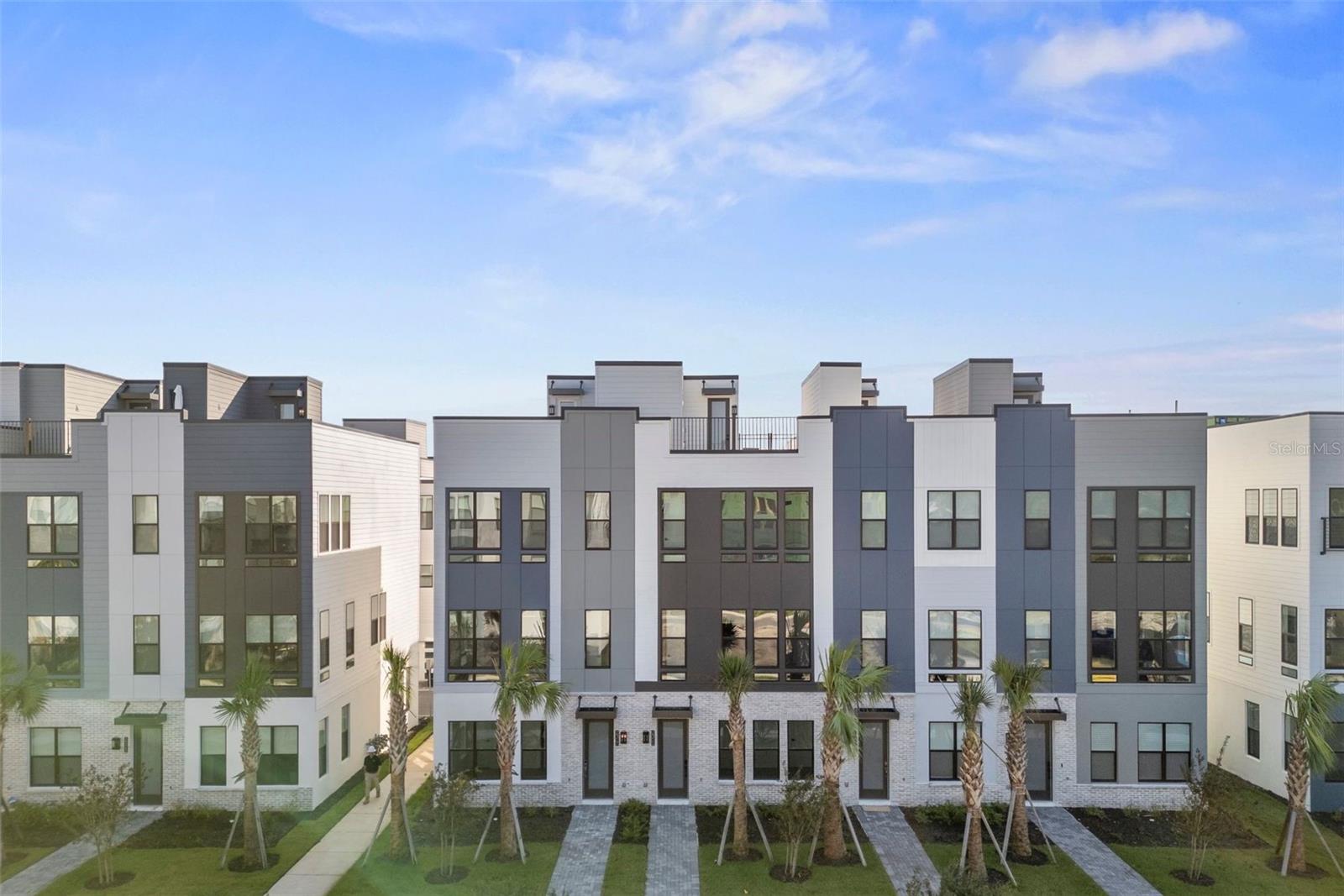 Step inside this gorgeous brand new Toll Brothers townhome 3br and 3.5b plus rooftop deck looking over the city beautiful. This grandeur townhome is an unrivaled choice for a refined living experience. The spacious living area lays out stunning costumed wood tile plank flooring and will welcome you with an abundance of natural light and plenty of sunshine entering your home. The chefs kitchen offers gas range cooking, high end Kitchen-Aid appliances, quartz countertops, plenty of cabinets with pantry and a large kitchen island for entertaining. Recess canned lighting and upgraded lighting fixtures is placed thru-out the home. The primary bedroom located on the 3rd floor is quite large and can easily fit a California King bed. The primary bedroom also has a large walk in closet and a primary bathroom with dual vanity sinks and costumed floor to ceiling tiled walk in shower. This particular townhome has an upgraded ROOFTOP terrace where you can entertain guest and enjoy the beautiful Orlando weather while enjoying your morning coffee. This townhome comes with a private 2 car garage and brand new Whirlpool washer and dryer. Come see this amazing home today! Located near downtown Orlando and College Park, The Brix at The Packing District is an exclusive community featuring 135 modern townhomes. The Brix at The Packing District includes a dog park and a mew between select buildings with a park-like setting, including gathering and seating areas. Additionally, the community will be situated within walking distance of an array of all-new amenities, including the Orlando Tennis Centre, YMCA Family Center, a bike lane leading directly into College Park, a food hall and beer garden, a futuristic regional park with a pond overlook, a 40-acre urban farm, sports fields, an amphitheater pavilion, an entertainment stage, scenic walking and jogging trails, and more. Residents will also enjoy proximity to top-rated schools, colleges, and universities; nearby shopping, dining, arts, and recreation in College Park, downtown Orlando, and Winter Park; and convenient access to the region’s world-renowned attractions and entertainment via major highways, including State Road 408 and I-4.