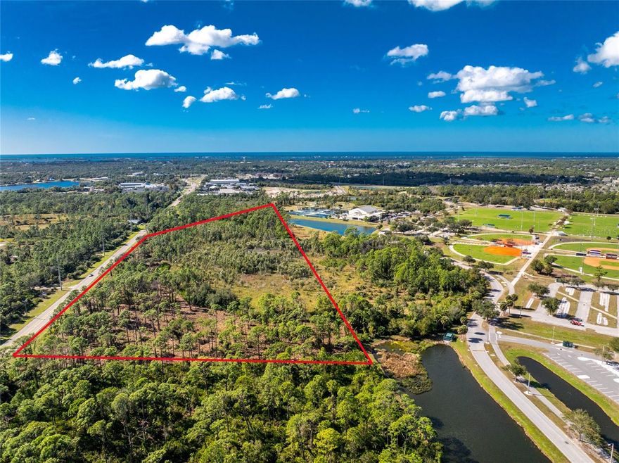 Rare opportunity to acquire a highly visible 15 acre commercial development site along South River Road, zoned ILW - Industrial Light & Warehousing, within the rapidly growing Wellen Park Corridor. The property backs directly up to greenspace and retention ponds located within the Sarasota County owned Englewood Sports Complex, providing a defined rear boundary and buffering from adjacent uses. The property offers approximately 1,000 feet of frontage along River Road. The site includes approximately 6.03 acres of usable land following approved wetland mitigation, with all non-developable acreage located at the rear of the property. This layout allows for an efficient building footprint and strong road frontage. Wetlands and mitigation areas are approved and clearly delineated under the current civil plan, offering clarity and certainty for future development. Positioned on a major arterial roadway, the property benefits from excellent visibility and traffic exposure and has received positive feedback from engineering and trade professionals regarding its development potential. Utilities are readily accessible, with electric service at the property line, water connection on the south side of South River Road, and planned sewer service via a lift station connecting to an 8-inch force main through the Englewood Water District. The substantial buildable footprint is well suited for a wide range of commercial or light industrial users seeking visibility, accessibility, and a strategic location within one of the area’s fastest-growing corridors. The property is located less than one mile from where South River Road transitions into Dearborn Street, near the local post office providing you plenty of convenience and accessibility for your commercial project.