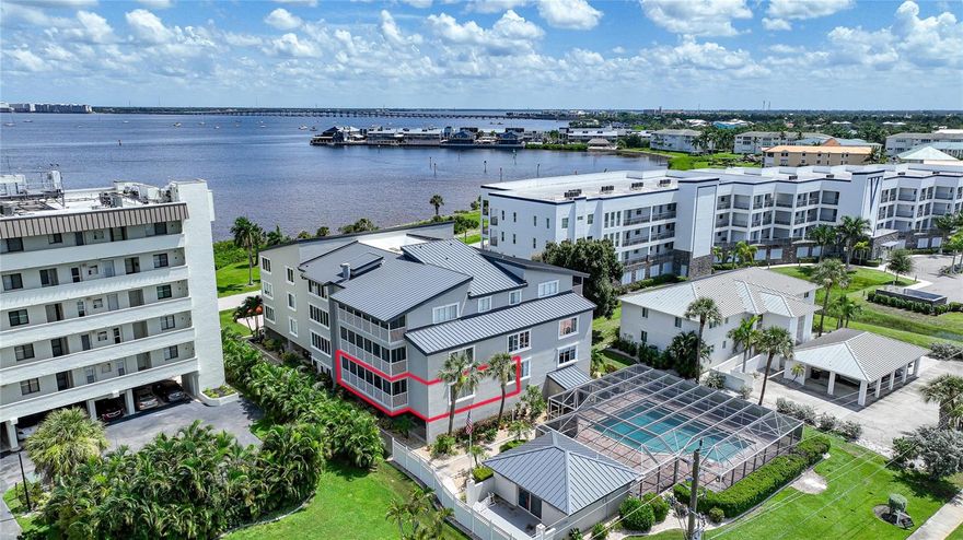 BEAUTIFUL PARTIAL PEACE RIVER & CHARLOTTE HARBOR VIEWS from your screened balcony. This spacious 2-bedroom, 2-bath condo is ideally located across the street from Elizabeth & Wilson Park on the Peace River and 0.6 miles to Fishermen’s Village, offering the perfect blend of waterfront living and convenience. The light-filled interior has been extensively updated May 2026 with stylish modern finishes throughout. The kitchen and both bathrooms feature granite countertops, while recent improvements include luxury vinyl plank flooring throughout the entire unit, fresh interior paint on walls, ceilings, trim, and doors, all new baseboards, and six new ceiling fans. The kitchen features a full stainless steel appliance package. The second bedroom could act as a secondary primary with direct access to the second bath. Both bathrooms have been beautifully updated with new sinks, faucets, vanities, and new vanity lighting. Additional upgrades include new lighting in the kitchen and foyer, plus custom barn doors leading from the primary bedroom into the primary bath.
Major mechanical updates include a new HVAC system installed in December 2022. The building offers elevator access to this first-floor unit, assigned covered parking under the building, and impact windows and doors for added peace of mind. Community amenities include a heated pool, pool house with restroom facilities, and grilling area. The community has also undergone numerous exterior improvements including a new metal roof, fresh exterior paint, updated balcony railings, and a new pool screen enclosure. Enjoy low-maintenance Florida living with beautiful water views in one of Punta Gorda’s most desirable waterfront locations. Schedule your private showing today.