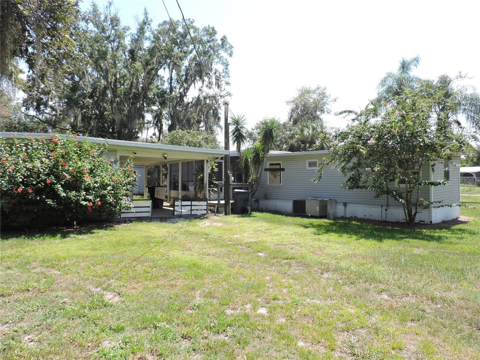 NICE BIG 1/2 ACRE LOT WITH LOTS OF TREES ALL FENCED IN FROM CORNER TO CORNER.... JUST DOWN THE STREET FROM THE PUBLIC BOAT RAMP FOR LAKE PIERCE. SITTING ON THIS NICE PROPERTY IS A UNIQUE HOME...A 2 BEDROOM 1 BATH SINGLE WIDE MOBILE HOME WITH A SCREENED PORCH AND COVERED AREA AND A 1 BEDROOM AND BATH DETACHED BUILDING WITH WASHER DRYER HOOK UP WITH A PATIO IN BETWEEN. ALSO ANOTHER DETACHED BUILDING FOR AN OFFICE AND A STORAGE ROOM. A MUST SEE PROPERTY.