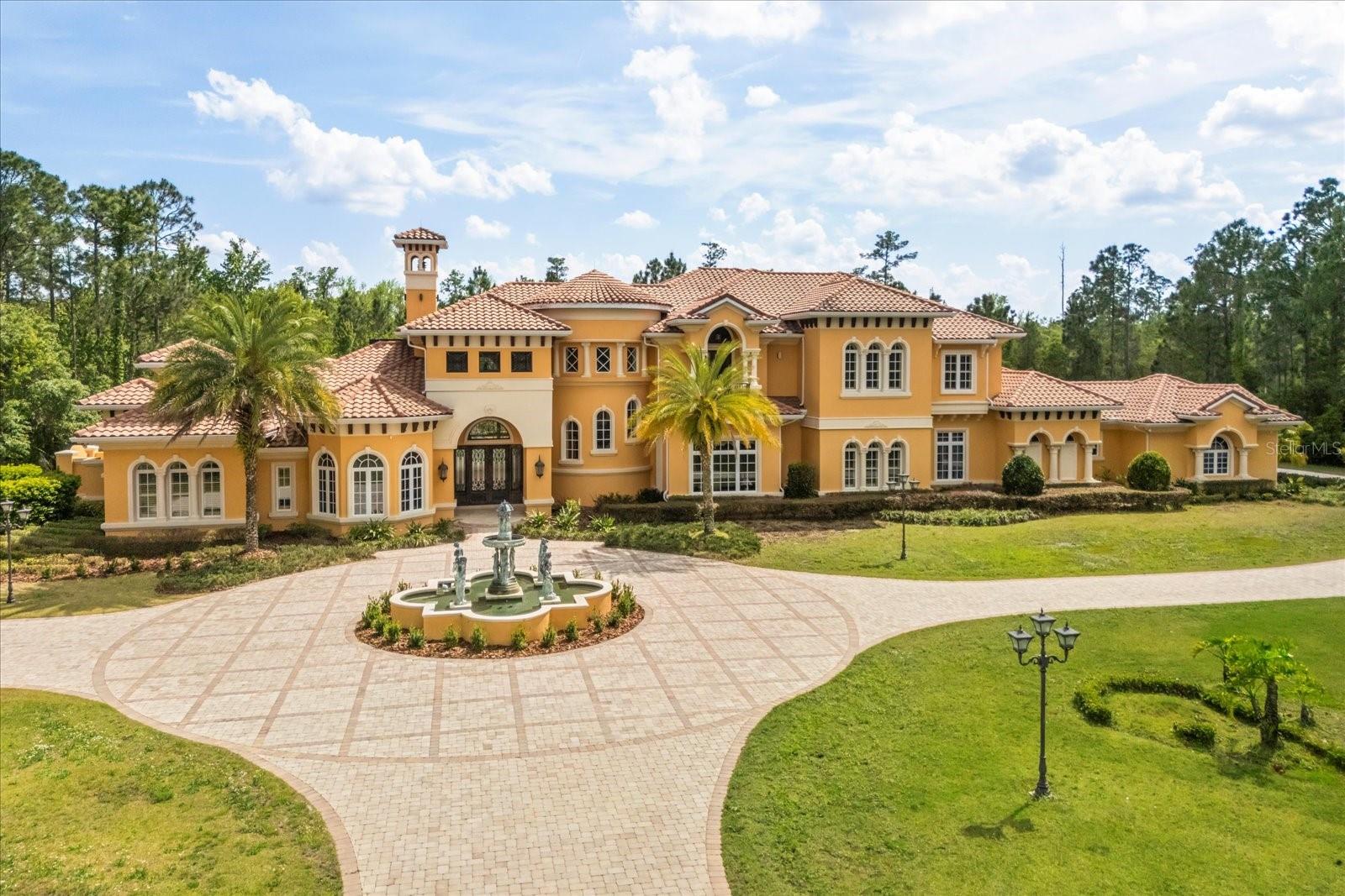 Welcome to a truly unparalleled luxury estate, nestled on 5 acres of serene privacy. This custom-built masterpiece, completed in 2009, boasts an impressive 11,138 square feet of meticulously designed living space, where every detail has been thoughtfully curated for the discerning homeowner.
As you enter through the private gate, you are greeted by a stunning family room featuring a handcrafted stone gas fireplace and soaring ceilings that create an inviting atmosphere. The elegant curving marble staircase, adorned with a magnificent Swarovski crystal chandelier, sets the tone for the opulence that awaits.
This estate offers 5 spacious bedrooms, each with large walk-in closets and en-suite bathrooms, ensuring comfort and privacy for family and guests alike. The main living areas are enhanced by exquisite woodwork, including a gorgeous dining room and a living room that seamlessly connects to the outdoor oasis through sliding glass doors that open at the corner, perfect for entertaining.
Indulge in the ultimate entertainment experience in the media room, complete with luxurious seating and a stunning chandelier commissioned from Tiffany's in New York. The primary suite is a true retreat, featuring a cozy sitting area and an expansive closet. Additional highlights include a gym with a steam room, an office/study/library, and an upstairs game room that overlooks a spacious covered balcony.
The outdoor amenities are equally impressive, featuring a large pool with a spa, ample undercover seating, an outdoor kitchen, and tennis courts, all surrounded by lush landscaping and majestic oak trees. The estate also includes a wine cellar, a wet bar with custom woodwork, and coffered ceilings adorned with unique prints.
With a 4-car side garage and an attention to detail that is truly one of a kind, this estate is unlike anything you have ever seen. Experience luxury living at its finest—schedule your private tour today and discover the extraordinary lifestyle that awaits you.