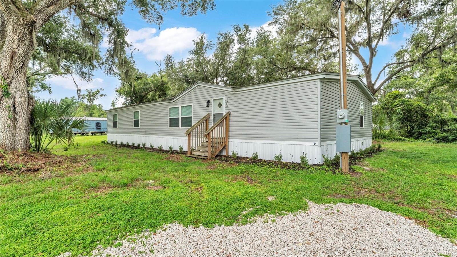 Beautifully updated 4 bedroom, 2 bathroom mobile home in Mulberry! This spacious home features brand-new flooring, fully renovated bathrooms, and a modern kitchen with granite countertops and stainless steel appliances. It also has a brand-new AC and a durable metal roof for added peace of mind. New electric panel and service. New hurricane straps, siding, and brand new septic. With a bright, open layout and quality finishes throughout, this move-in ready home is primed for a new family.