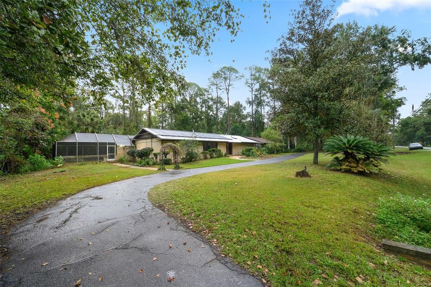 Short Sale. This is a great opportunity to own a timeless Gainesville residence that exudes mid-century sophistication and architectural integrity. Sitting on an acre and built in 1965, this home offers a captivating blend of period design and modern livability. Distinctive built-ins, clean lines, and curated craftsmanship showcase the thoughtful details of a bygone era, each space designed with function and classic living in mind.
The living areas are open yet defined, anchored by a statement that highlights the home’s original design intent. Expansive glass doors bring in natural light and invite you to the tranquil outdoor retreat beyond. The screened-in pool and covered lanai create a seamless indoor-outdoor flow perfect for entertaining or unwinding in privacy. The pool area offers convenient access points into the home through multiple poolside entryways.

From its classic design to the spacious layout and solid construction, this home offers a canvas for restoration or refinement—an ideal match for buyers who appreciate character and quality. Located in a quiet, established neighborhood near parks, shopping, and the University of Florida, this residence combines nostalgic charm with enduring potential. Experience the grace of mid-century design and the opportunity to make it your own.

Owner-occupied short sale. Do not disturb occupants. Confirm approved appointment time prior to showing.