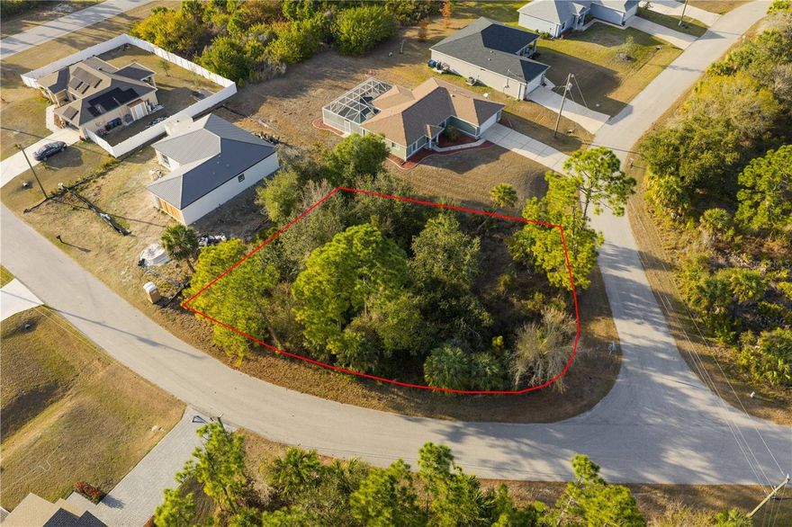 DON'T MISS THIS RARE OVERSIZED CORNER LOT IN RAPIDLY GROWING NORTH PORT! 
Opportunities like this do not come around often. In a market where space is the ultimate luxury, this oversized parcel is a standout.  Whether you are a savvy investor looking for a high-value hold or a homeowner ready to break ground on a custom masterpiece, this is the one you've been waiting for. This oversized corner lot offers exceptional space, privacy, and flexibility — a rare combination in an established residential neighborhood surrounded by beautiful newer homes.  Positioned on a quiet curve with dual road frontage, this premium homes site offers extra privacy with natural Florida landscape,  Excellent curb appeal potential.  The unique corner positioning offers enhanced design options and a grand entrance opportunity — perfect for buyers wanting something more distinctive than a standard interior lot. Located in desirable North Port, this property sits minutes from: Shopping, dining, parks & recreation, close access to  I-75. Minutes away from the Atlanta Braves Spring Training Cool Today Park, the Wellen Park shopping district with world-class Gulf beaches and pristine golf courses. They are not making more land-especially not corner lots like this.
New construction continues to move quickly in this area, making oversized corner lots increasingly scarce. Whether you’re building your dream Florida home or investing in one of Southwest Florida’s fastest-growing communities, this is a strategic and valuable purchase.
Corner lots of this size and location are limited — secure it before it’s gone. NO HOA/CDD Fees enjoy the freedom to build on your own terms and your own timeline without the burden of monthly dues or restrictive overhead. Well & Septic needed.  Please submit offers on vacant land contract with proof of funds. No survey's have been done on property all measurements are to be verified by buyer.