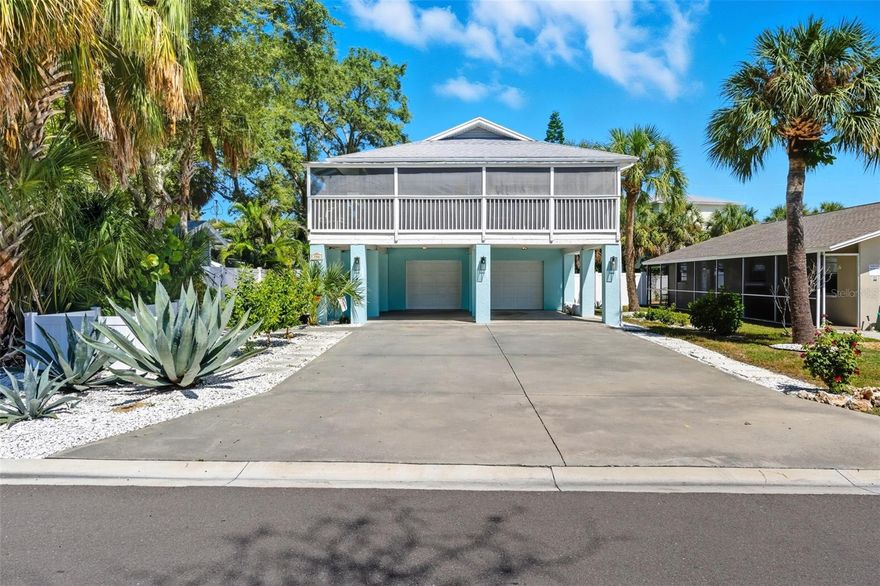 Relax on the rocks – coastal Key West charm near the beach! Welcome to this adorable coastal-eclectic Key West–style elevated home just two blocks from the beach. This fully furnished three-bedroom, two-bath retreat blends comfort, style and fun — ideal as a primary residence, vacation getaway or turnkey investment property with a strong rental history. Go inside to find bright, inviting interiors with updated stainless steel appliances, full-size washer and dryer, and plenty of space to unwind. Enjoy morning coffee or an afternoon nap in the hammock on your large screened front balcony or take in backyard views from the rear balcony overlooking a private oasis designed for entertaining. The oversized two-car garage plus two-car carport provide ample parking and storage. Outside, the backyard is a coastal playground featuring a cornhole setup, barbecue grill, fire pit with seating, outdoor Edison lighting, jacuzzi and ping pong table, ideal for making memories with family and friends. In a golf cart–friendly community close to shops, restaurants, pubs and live music, you’ll also have easy access to the Jolly Trolley for a carefree ride from Clearwater Beach to St. Pete Beach. Spend your days shelling, snorkeling, paddleboarding, fishing, boating, jet skiing or simply watching the breathtaking Florida sunsets.