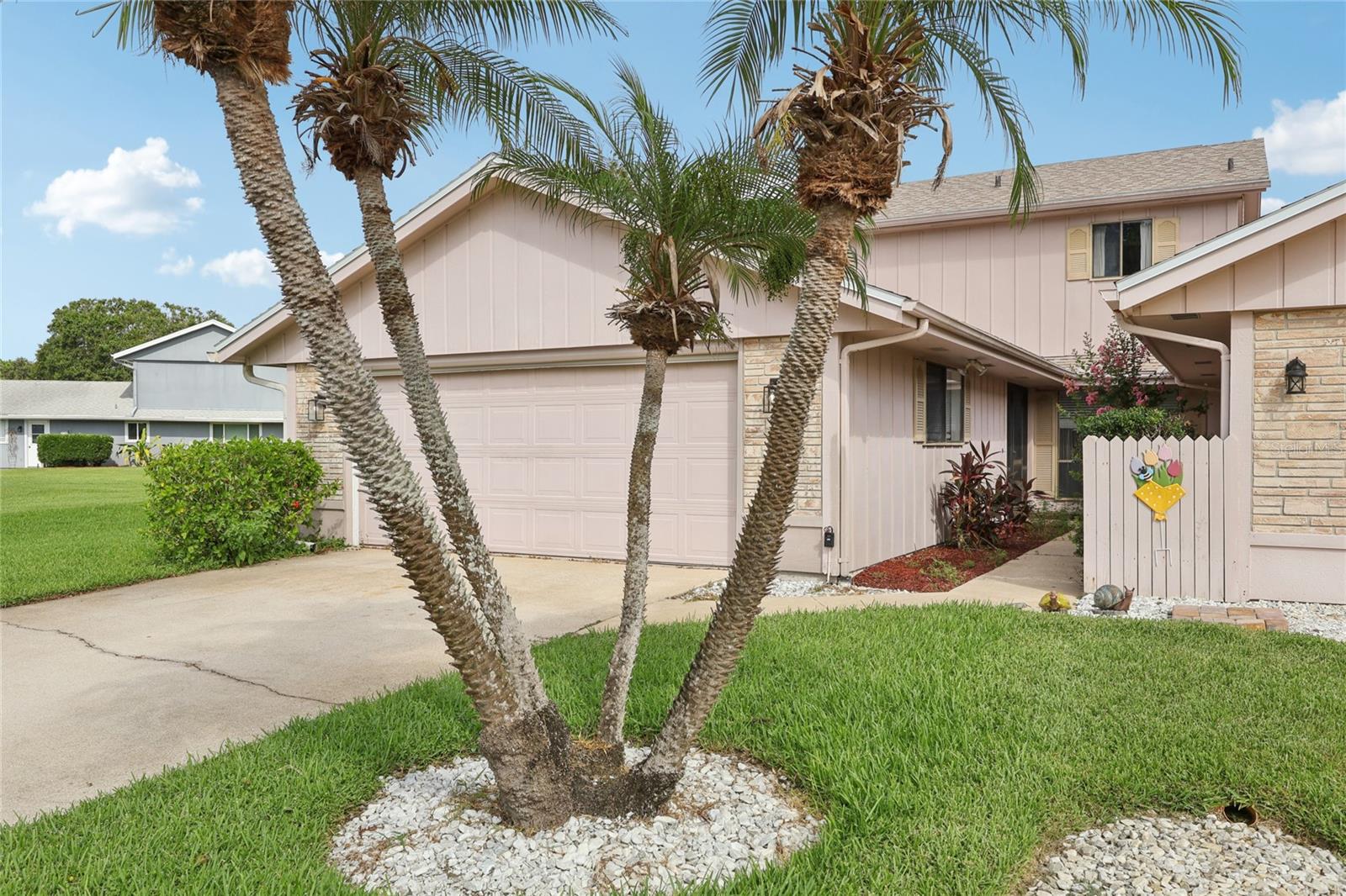 Welcome to Fairgreen VI, a sought-after golf and lakefront community in the heart of New Smyrna Beach. This spacious 3-bedroom, 2.5-bath home offers over 1,800 square feet of air-conditioned living space and more than 2,600 total square feet, including a 2-car garage and enclosed Florida room with serene lake views. Enjoy peace of mind with a NEW ROOF (2022) and UPDATED KITCHEN featuring quartz countertops, new cabinetry, and appliances (2023).The primary bedroom and ensuite bath are located on the main floor, along with a guest half bath for added convenience. Upstairs, you'll find two additional bedrooms, a full bath, and exceptional storage—including a walk-in closet in the hallway, two additional closet areas, and a generous under-stair closet downstairs. The primary bedroom, living room, Florida room, and second bedroom all offering a picturesque views of the tranquil community lake, while the third bedroom features a beautiful view of the golf course.The eat-in kitchen includes a pantry and opens to the formal dining area and large living space, creating an ideal layout for entertaining or everyday living. The home is also wired for a generator hookup, perfect for storm season preparation. This charming home is perfectly nestled between Hidden Lakes Golf Course and the New Smyrna Beach Golf Course, and is less than 5 miles from the beach. HOA dues are just $300 annually and include irrigation water, sprinkler maintenance, termite bond, and common area care. Conveniently located near the New Smyrna Beach Airport and only 7 minutes from the North Causeway, this location provides quick access to the river, beaches, golf clubs, and the vibrant shopping and dining scenes of Canal Street and Flagler Avenue. Don’t miss this opportunity to enjoy the best of New Smyrna Beach living—schedule your private showing today!