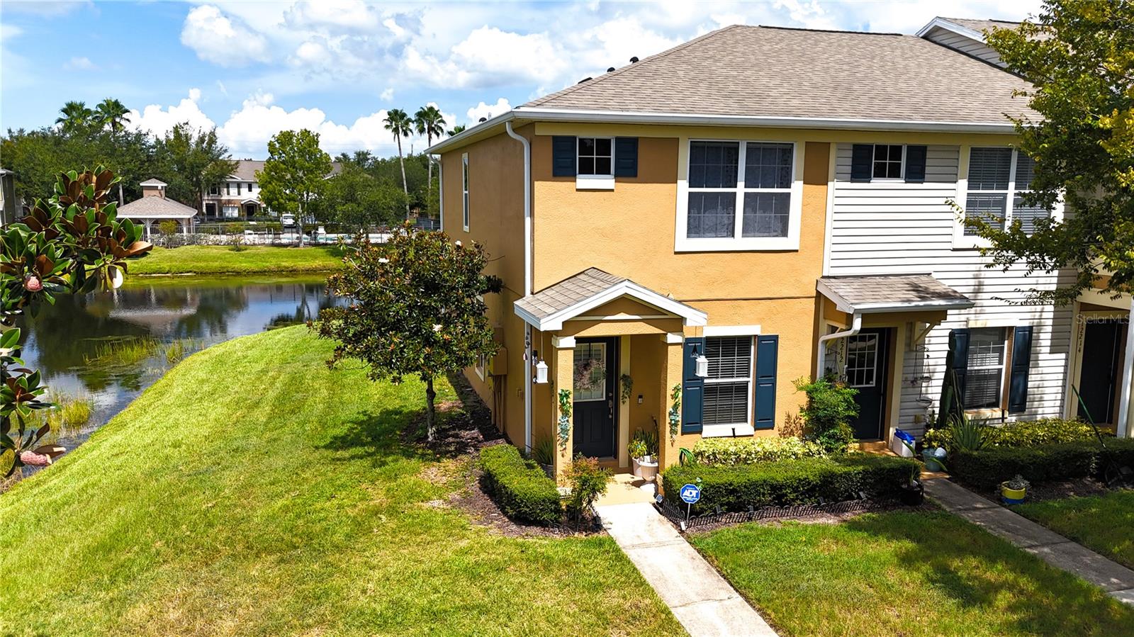 Discover this exceptional townhouse, once the model home, on a prime corner lot with breathtaking water views! This bright pristine 2-bedroom, 2.5-bath residence features no carpet, each bedroom with its own bathroom, and convenient upstairs laundry hookups.Relax in your beautiful screened-in lanai, equipped with built-in storm shutters and electric shades. Enjoy the community pool and the privacy of a gated community, all while being just minutes from restaurants, schools, hospitals, and shopping.With HOA covering lawn maintenance and water, you can focus on what matters most. Don’t miss this incredible opportunity at an exceptional price—schedule your showing today!