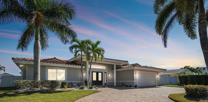 Welcome Home!  Enjoy the serenity of waterfront living in this gorgeous 3 bedroom 3 bath offering the ultimate Florida lifestyle. As you enter the double doors you are instantly greeted with a bright and airy space accented with gorgeous dark wood beams that span throughout the living space and into the vaulted ceilings. The open floor plan serves as an entertainer's dream layout with an abundance of hosting space. Gorgeous solid wood cabinetry surrounds the kitchen for an abundance of storage. Custom built-ins along the dining room are perfect for displaying your finest pieces as your guests indulge in a glass of wine. The vast kitchen boasts an expansive island along with top of the line appliances including a Wolf induction range, Miele dishwasher and a SubZero fridge that will surely impress the avid chef.
As you make your way into the main living quarters the views create an indoor/outdoor living experience that is the epitome of Florida living. A bonus room along the back of the home provides the perfect setting for an office or pool room overlooking the serene views of the water. Travertine pavers make way to a spacious covered seating area perfect for guests to lounge in the shade. Take advantage of the gorgeous Florida weather by taking a dip in the saltwater pool and spa or taking a sunset cruise on your boat with a 2018 40,000lb boat lift conveniently located in your own backyard. Paradise is the only way to describe this outdoor oasis. After a long day in the sun, retreat to your luxurious primary suite adorned with accent features like recessed wood plank ceilings, electronic blinds and stunning pool and water views. Relax in the primary bath equipped with serene design choices, dual sinks with plenty of quartz top counter space and a spa like walk-in shower. Impeccable care was taken to ensure it’s next owners can immediately begin living the lifestyle they have always dreamed. Since 2018 this home has been enhanced with a new roof, whole house generator and a completely renovated pool, spa and seawall. With only a 3 minute ride to the intercoastal and a 20 minute boat ride to the open water under the sand key bridge, this location couldn’t get any better than this. The best beaches in the world are calling your name. To schedule a private tour TODAY!