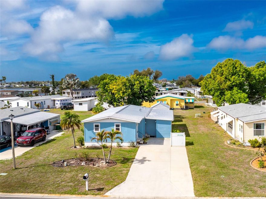 INVESTOR ALERT!  Take a look at this well priced doublewide 2 bedroom/2 bath manufactured home in Englewood's favorite "over 55" manufactured home park, Lemon Bay Isles. ROOF WAS REPLACED IN 2023 AND AC IN 2020 SO MAJOR $$$ THINGS ARE ALREADY DONE! Home also has IMPACT WINDOWS for peace of mind. Living/dining area features a cathedral ceiling and ceiling fan, built in hutch and laminate flooring for easy clean up! The Kitchen has ample cabinetry, GRANITE COUNTERTOPS, built in table, closet pantry and tiled flooring. Appliances include; French door refrigerator, dishwasher, and smooth top stove -ALL LG STAINLESS STEEL. The Primary bedroom has a cathedral ceiling and ceiling fan, walk in closet, plywood flooring and ensuite bath, which features a separate vanity area, plus step in shower. Guest bedroom also has a walk in closet and ceiling fan, and plywood flooring. Guest bath has a combo tub/shower and vinyl flooring, plus a walk in linen closet!  The lanai was enclosed and made into an actual living area, reflected in measurements as the Florida Room. (with impact windows!) Everyone will love the 11 x 29  MANCAVE, which also houses the washer and dryer!  Use this space as a game room, office, extra storage - you name it! There's also a newer 12 x 12 Garden shed that would be perfect for your lawn and garden tools. Home just needs some new flooring, paint and a little TLC!  Enjoy the amenities of the Edgewater Club, with swimming pool, clubhouse with lots of organized activities, tennis, shuffleboard and lots more - for only $250/yr.!  The area beaches, shopping, restaurants and everything you could want or need are within just  few minutes drive.  Call today for a private or virtual showing!
